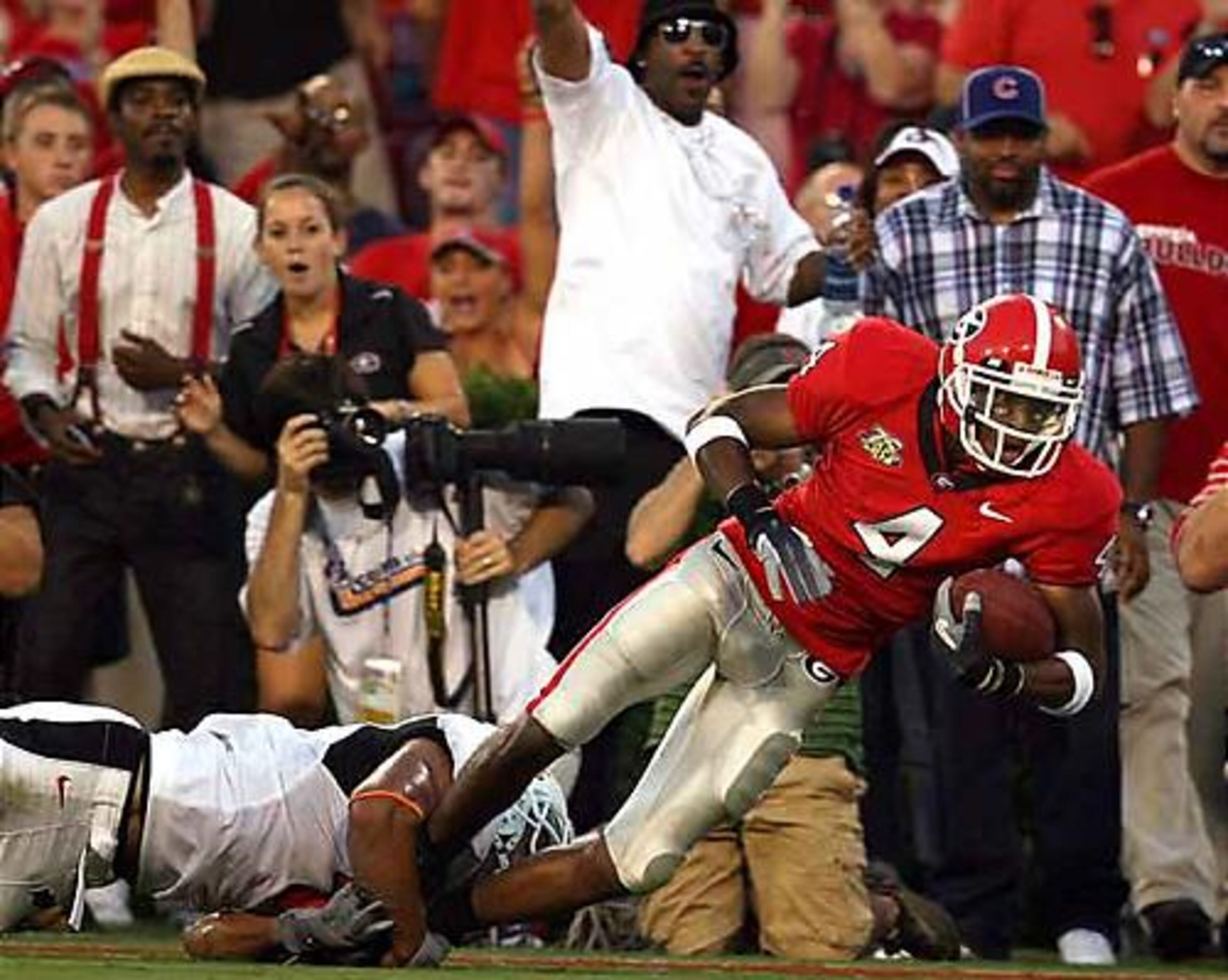 Georgia's Sean Bailey (4) makes a 47-yard run to help set up a Bulldog touchdown on the next play as he is taken down by Oklahoma State's Patrick Levine (4) in the second quarter.