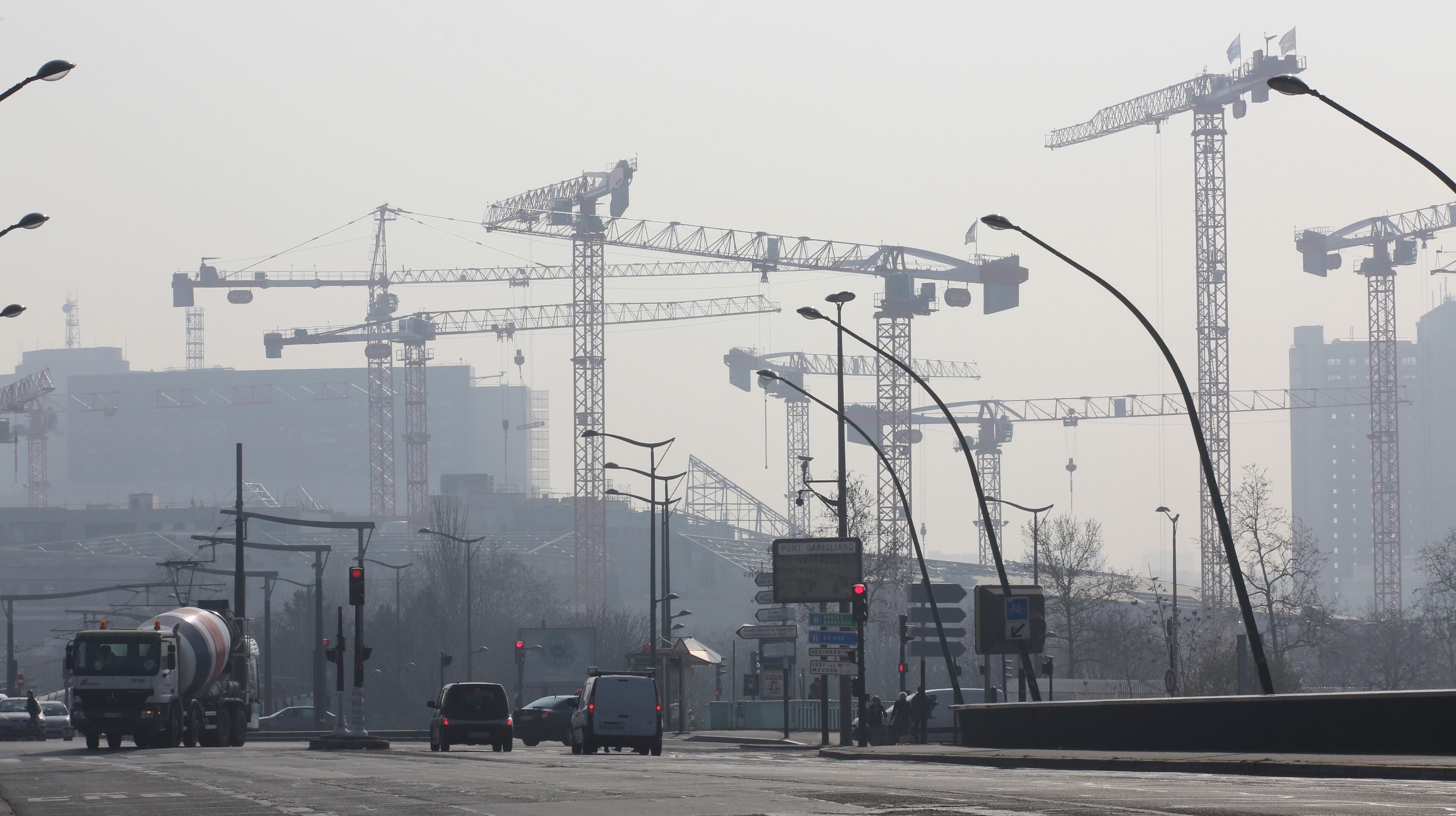 Cranes are seen through the smog in Paris, Thursday March 13, 2014 as pollution over the French capital is at high levels.