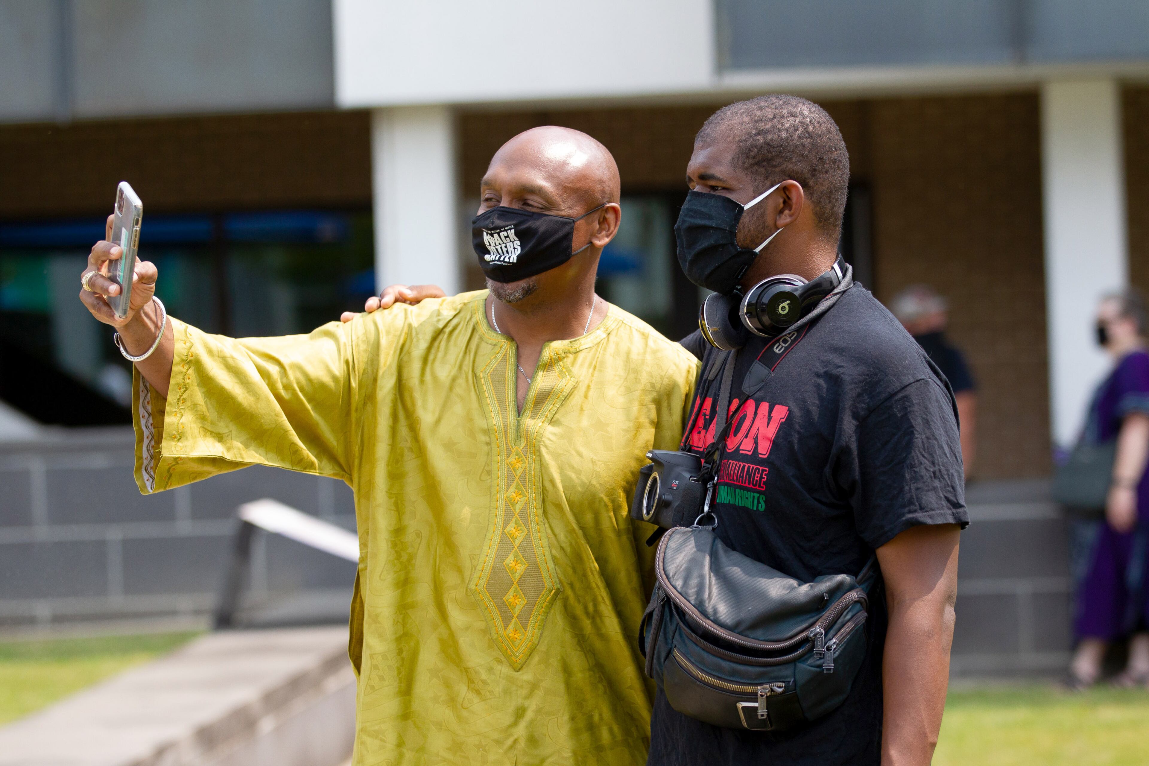 Mawuli Davis (left) and Keson Graham take a selfie during the unveiling ceremony of artist Ellex Swavoni's sculpture "What Sonia Said" in Decatur on Sunday September 12, 2021. STEVE SCHAEFER FOR THE ATLANTA JOURNAL-CONSTITUTION