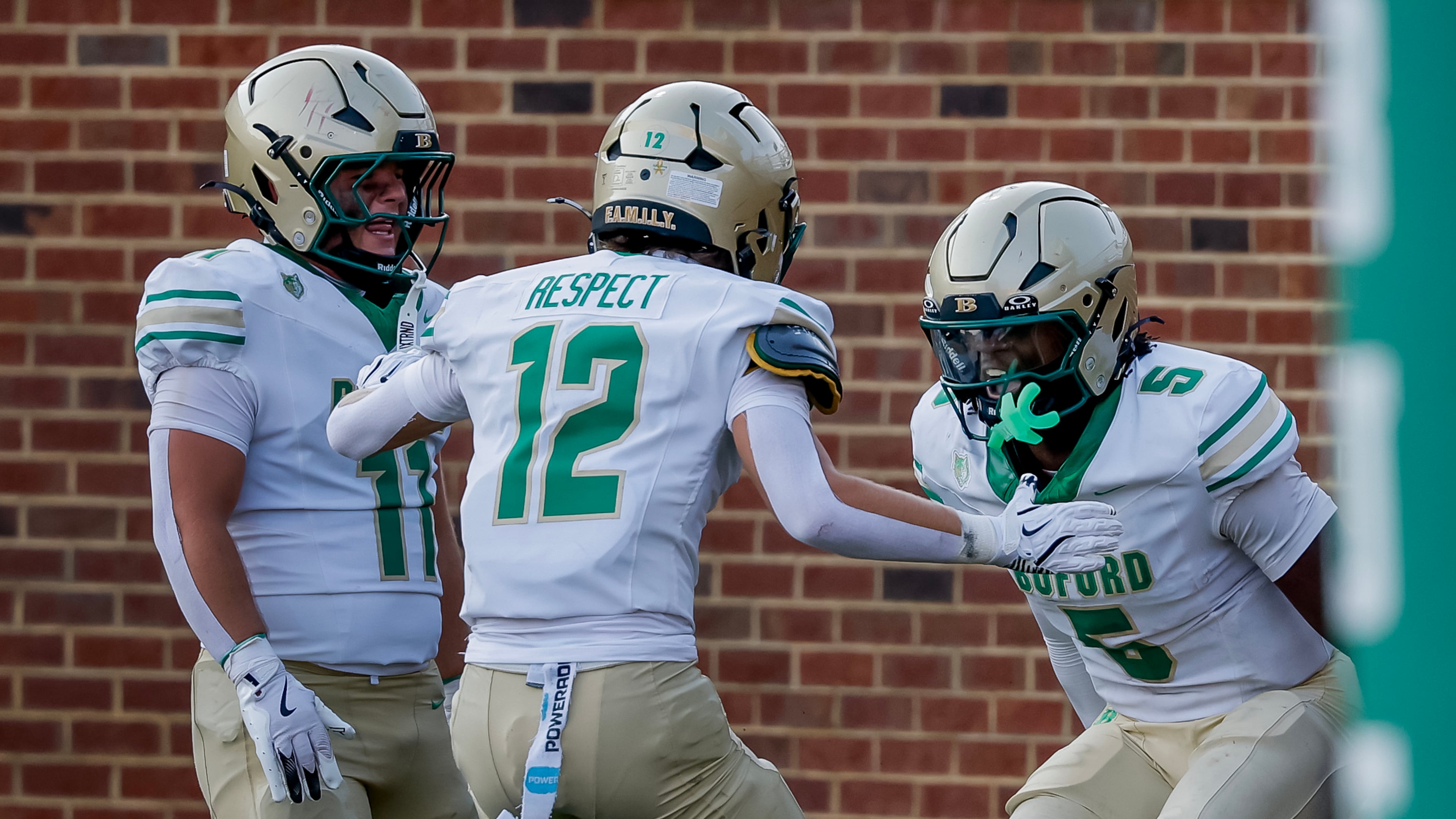 Buford quarterback DJ Hunter (5) celebrates his touchdown with Ian Chafin (12) and Owen Muraski (11) during the second half of a high school football game between Buford and Gainesville, Saturday, Aug. 22, 2026, in Buford, GA. (Erik S. Lesser for the AJC)