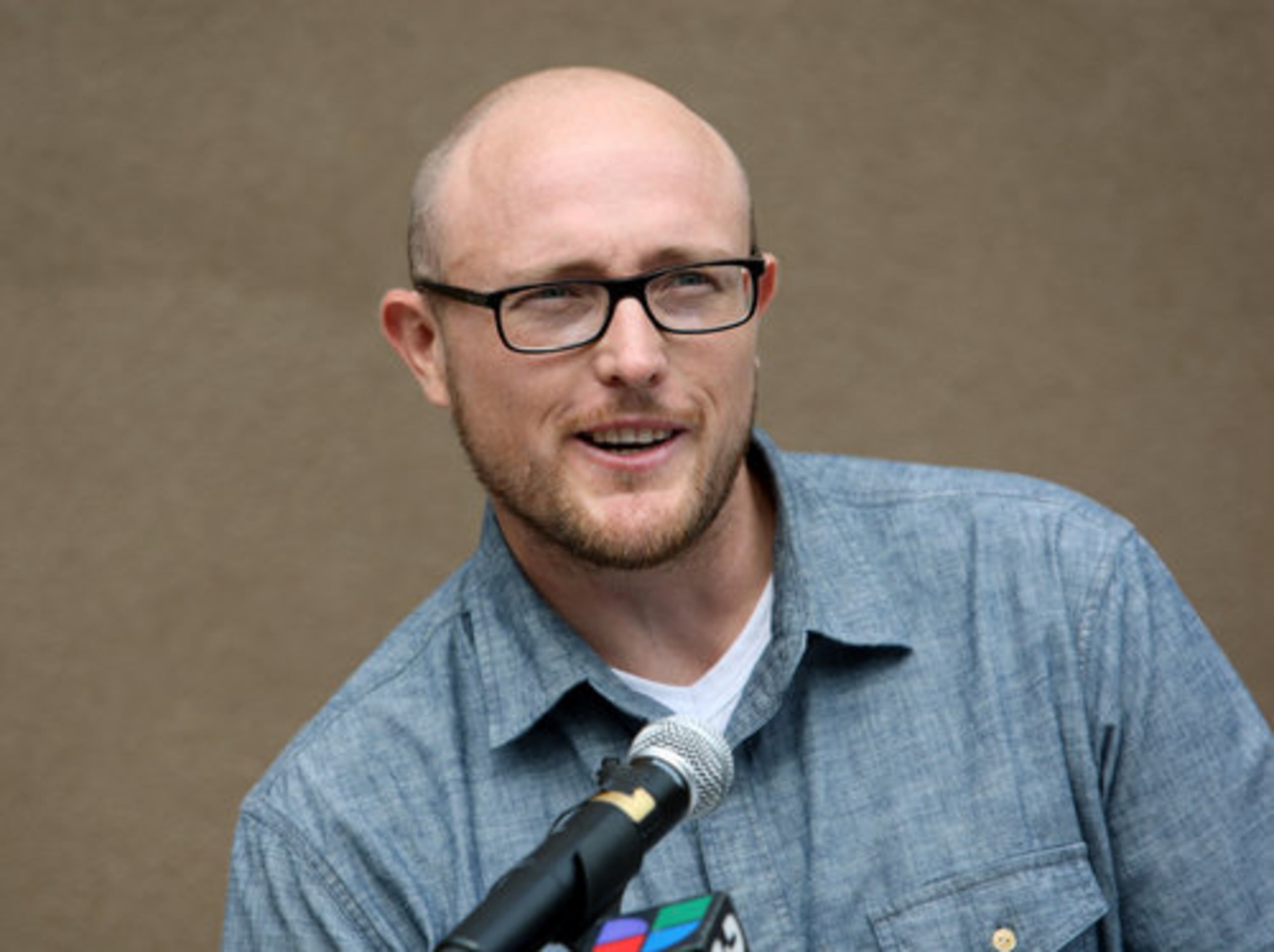 Artist Sean Schwab speaks during the dedication of his mural.