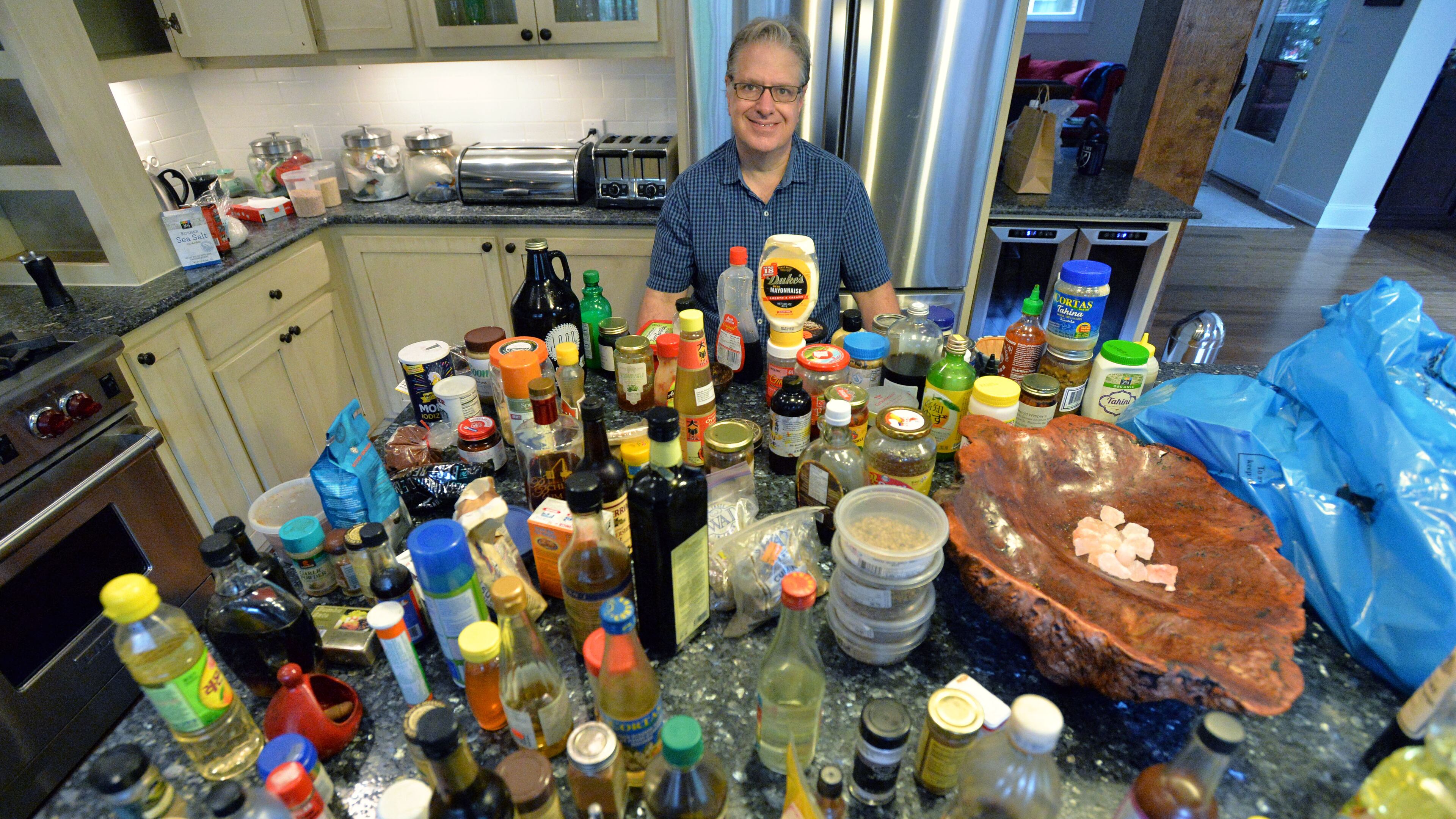 AJC's chief food writer and critic John Kessler cleans out his kitchen since he is moving to Chicago with his family on Saturday, July 18, 2015. As John Kessler prepares to sign off as the AJC's chief food writer and critic, he looks back at the great meals, good times and unforgetable people he met along the way. HYOSUB SHIN / HSHIN@AJC.COM