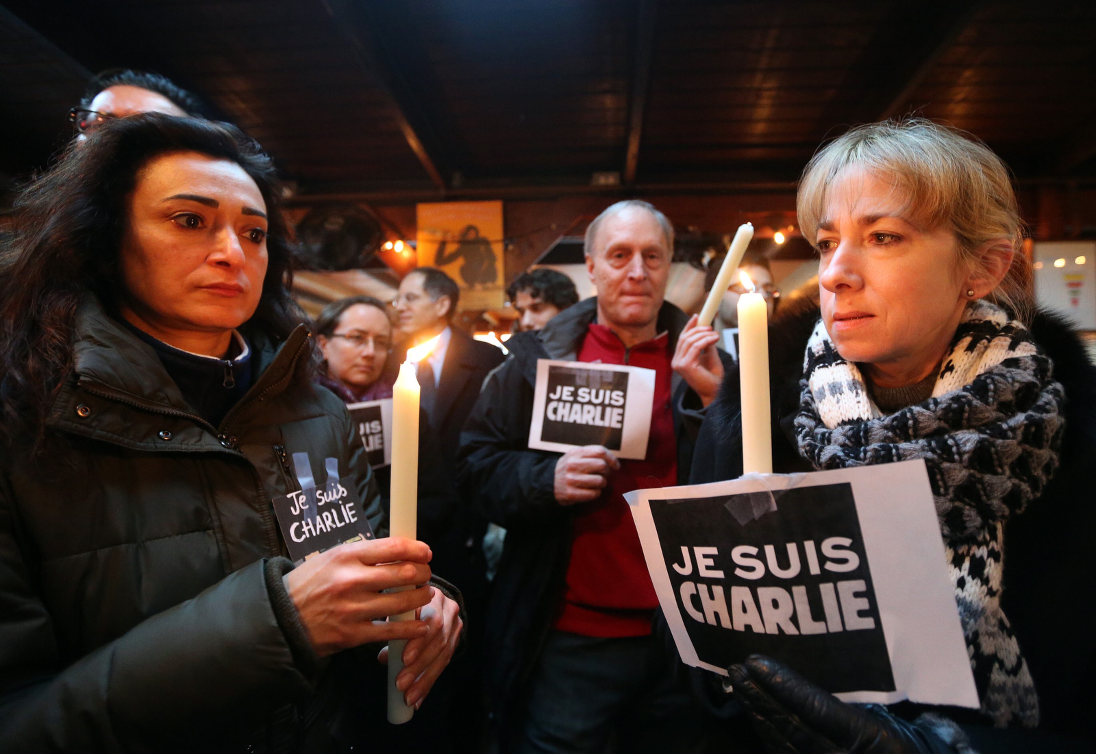 January 8, 2015 Atlanta: Mojgan Zarrabi, from left, Ken and Tami Brook participate in a gathering at Anis Bistro on Thursday evening January 8, 2015 to show support for France following the terror attack at the satirical newspaper Charlie Hebdo. BEN GRAY / BGRAY@AJC.COM