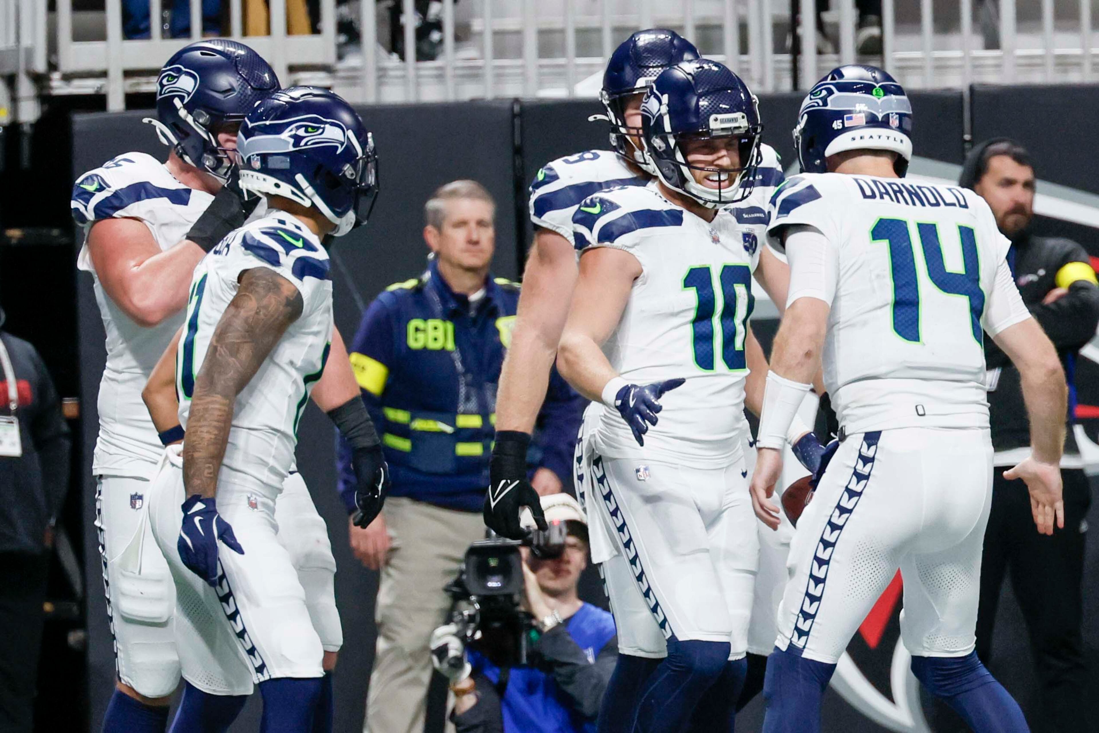 Seattle Seahawks wide receiver Cooper Kupp (10) celebrates with Seattle Seahawks quarterback Sam Darnold (14) after scoring a touchdown during the second half of an NFL game against the Atlanta Falcons at Mercedes-Benz Stadium in Atlanta on Sunday, Dec. 7, 2025. (Miguel Martinez/ AJC)