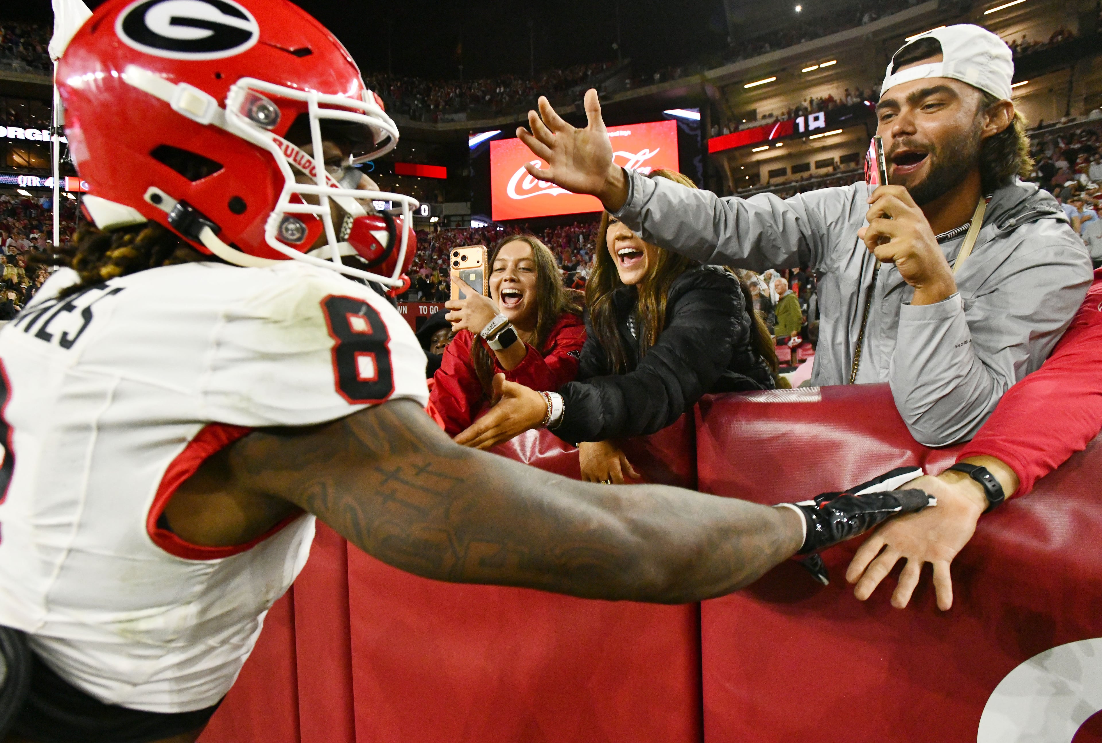Daps with your favorite player? Cool. Helmet slapping members of the opposing team? Not so much. (Hyosub Shin/AJC)