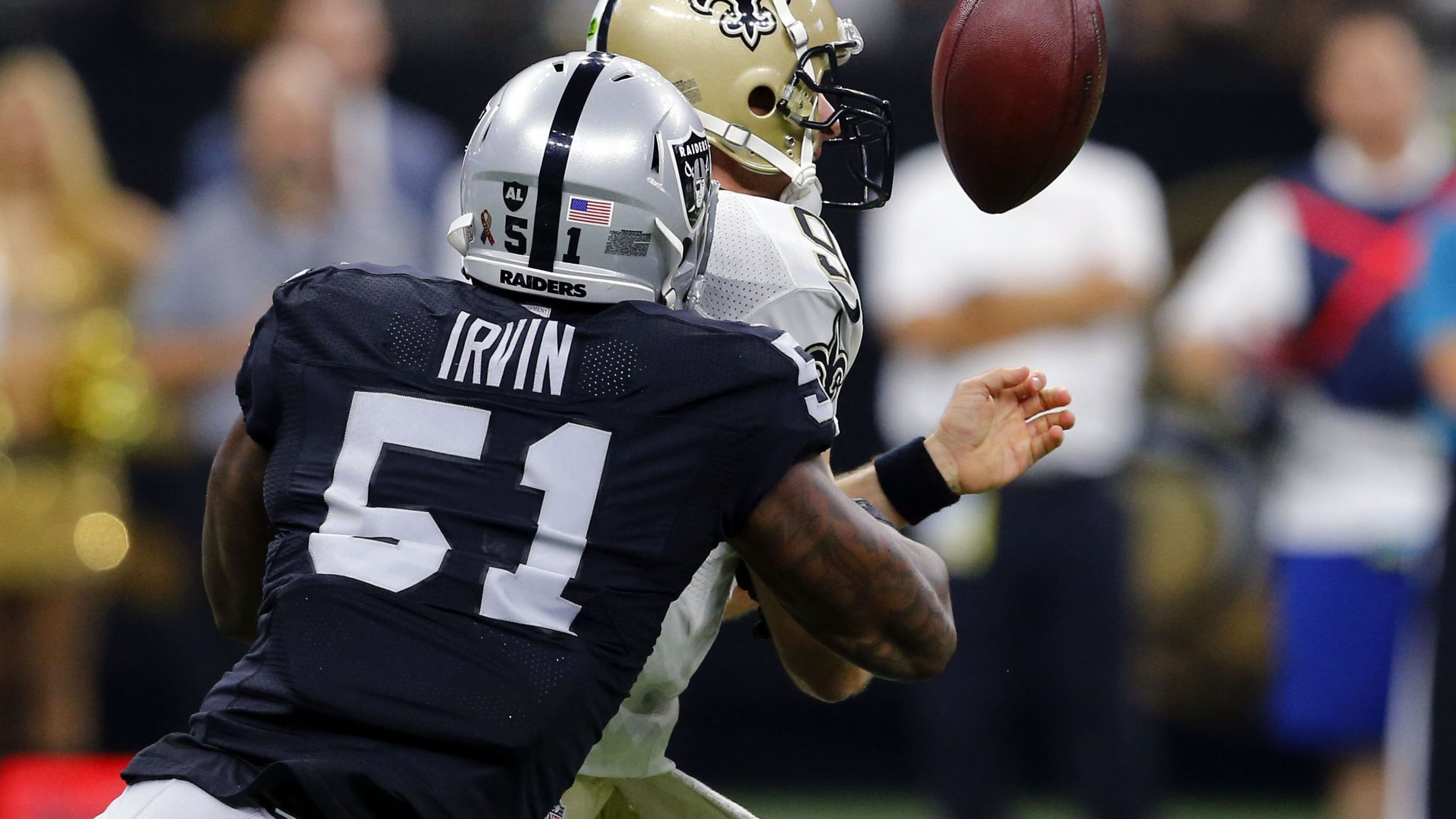 New Orleans Saints quarterback Drew Brees (9) fumbles as he is hit by Oakland Raiders linebacker Bruce Irvin (51) in the first half of an NFL football game in New Orleans, Sunday, Sept. 11, 2016. (AP Photo/Butch Dill)