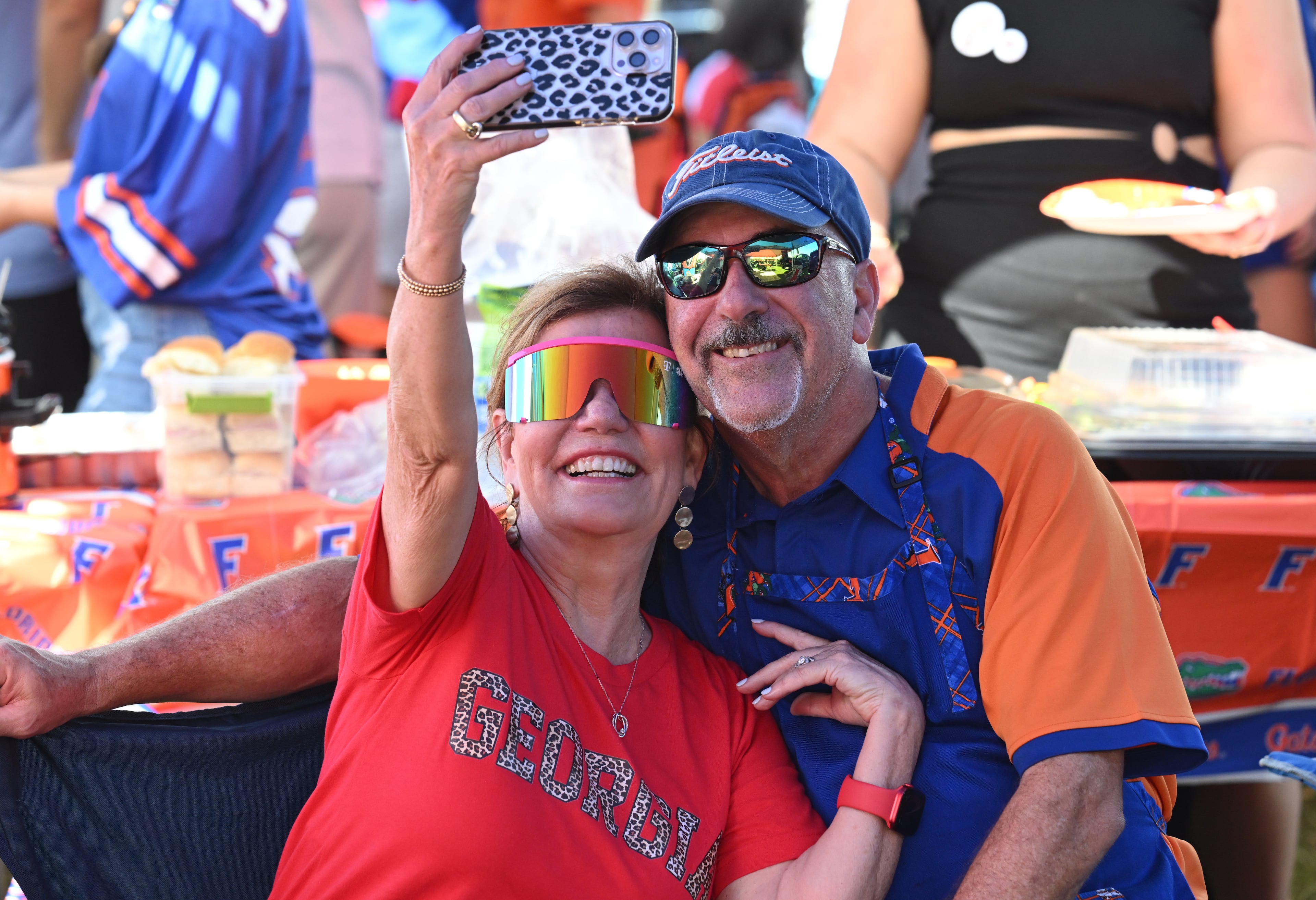Georgia fan Victoria Andras (left) and Florida fan and her husband Sam Andras pose for a selfie outside EverBank Stadium ahead of the NCAA football game between Georgia and Florida, Saturday, November 2, 2024, in Jacksonville, Fla. (Hyosub Shin / AJC)