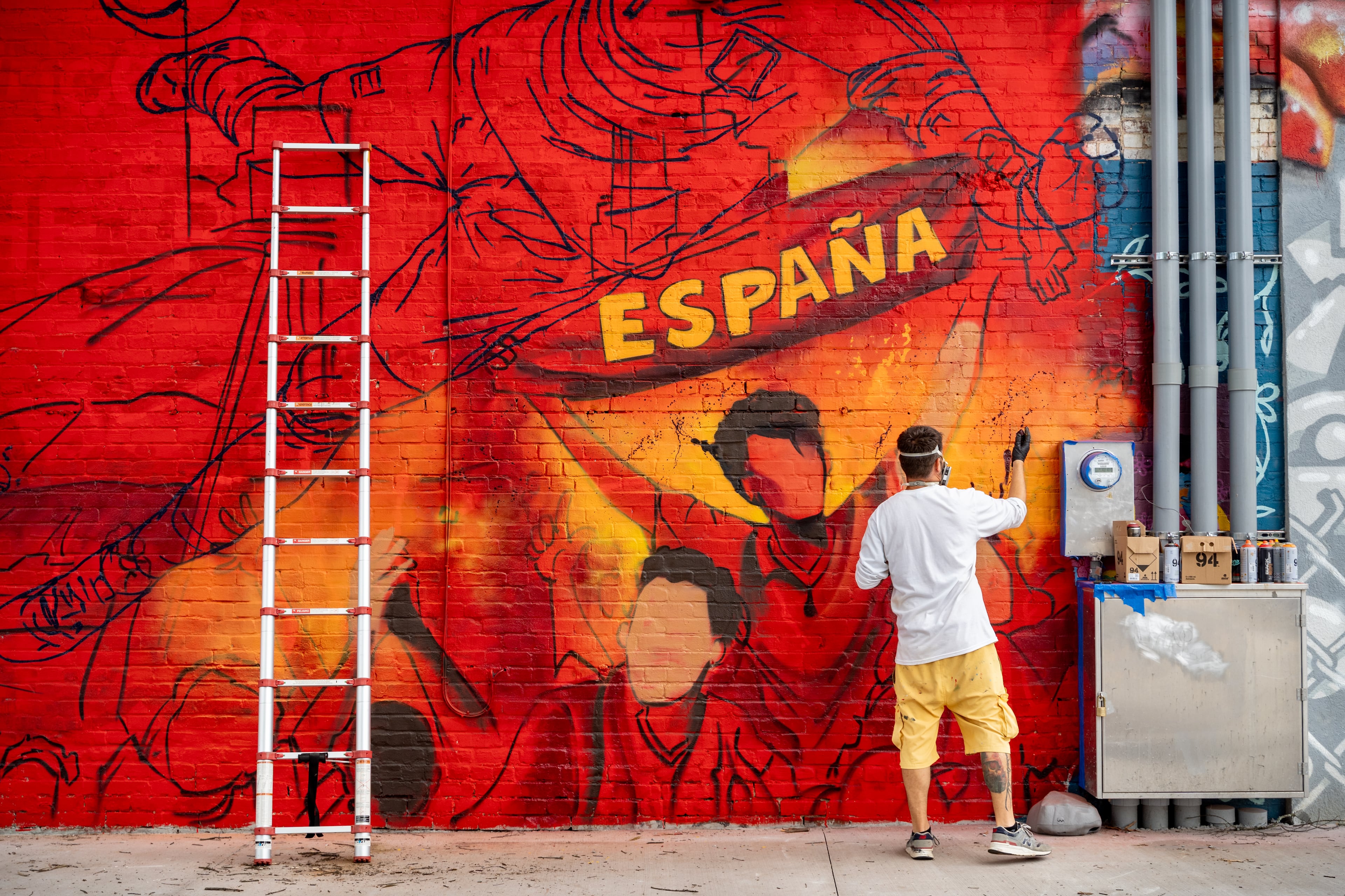 An artist with Kato Art paints a mural along Broad Street on Monday, June 8, 2026. (Ben Hendren for the AJC)