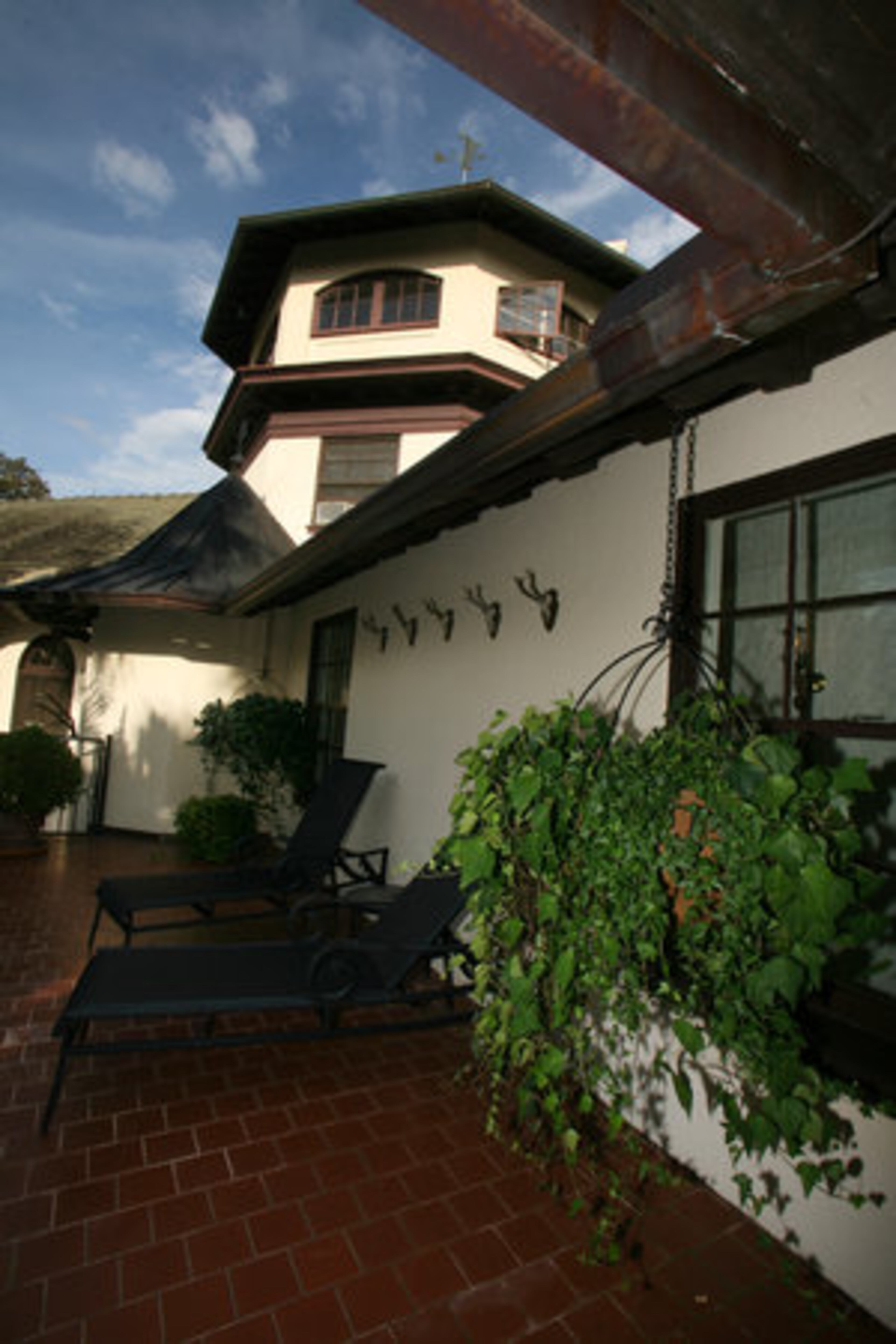 This private patio adjoins the master bath and overlooks the Ochlocknee River, which winds through the property. The turret above it contains a weather vane depicting Bussi Bear, another of Rolf Kauka's popular creations.