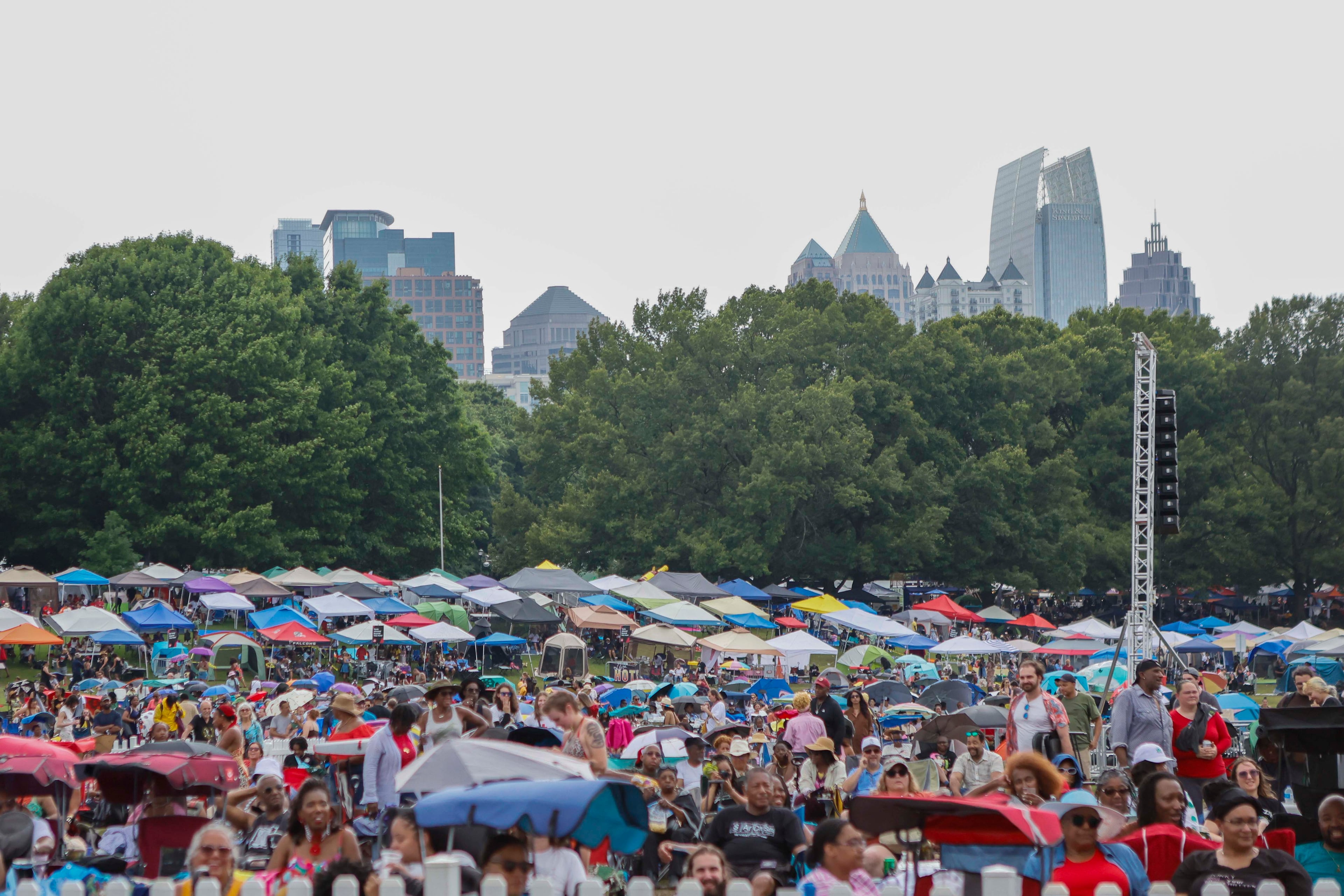 Festivalgoers gather on the lawn with tents and umbrellas during the Atlanta Jazz Festival at Piedmont Park on Sunday, May 24, 2026. The three-day annual event was held Saturday through Monday. (Miguel Martinez/AJC)