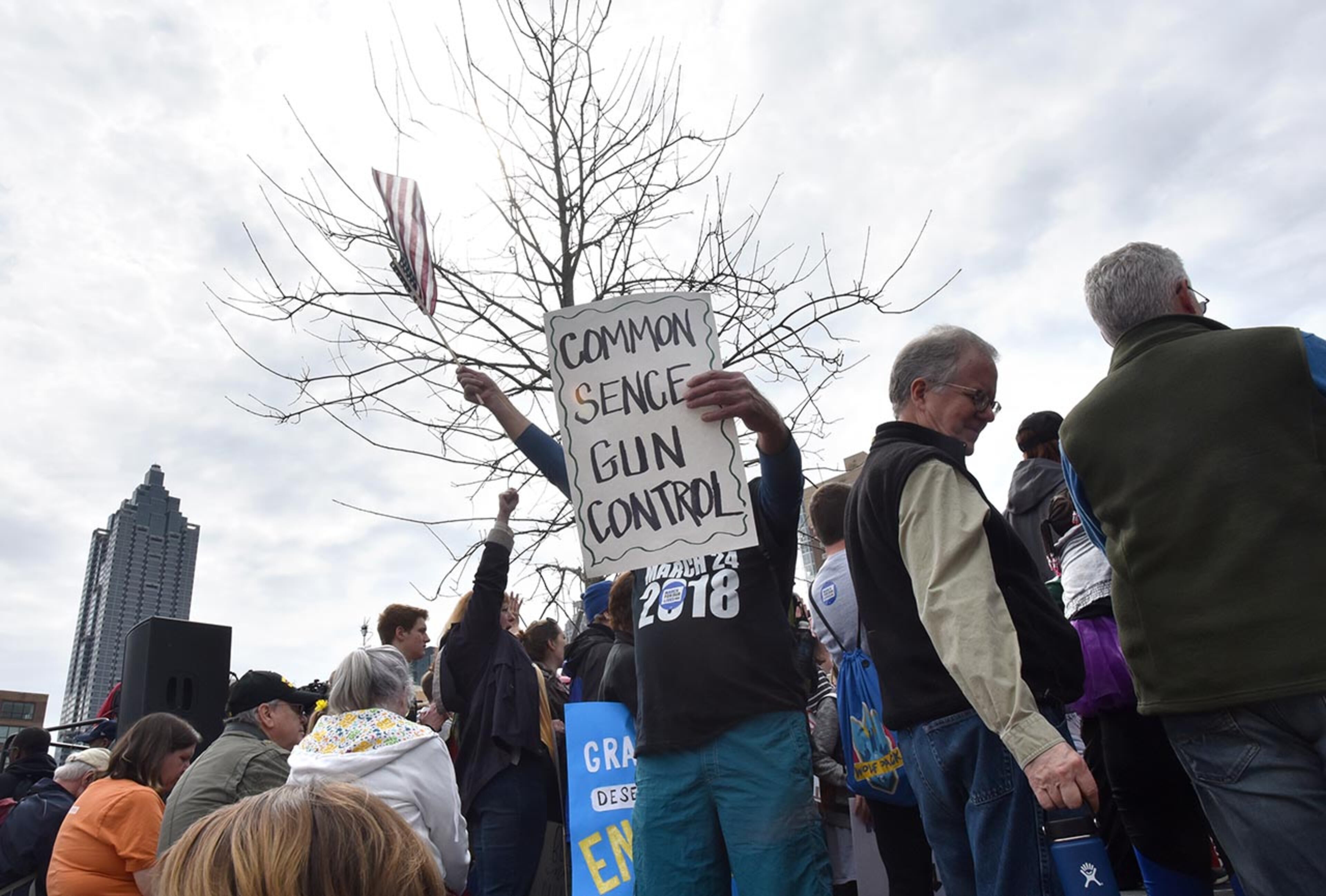 March 24, 2018 Atlanta - Ron Mercure waves an American flag as people gather to participate in the March For Our Lives rally at the Center for Civil and Human Rights before walking to Liberty Plaza on Saturday, March 24, 2018. Atlanta police estimated the crowd at near 30,000 for todayâÃôs March for Our Lives. People of all ages were drawn to one of the nationwide demonstrations in a movement begun by student survivors of last monthâÃôs mass killing in a Parkland, Fla., school. Some of those Florida students were among the speakers in Atlanta. HYOSUB SHIN / HSHIN@AJC.COM