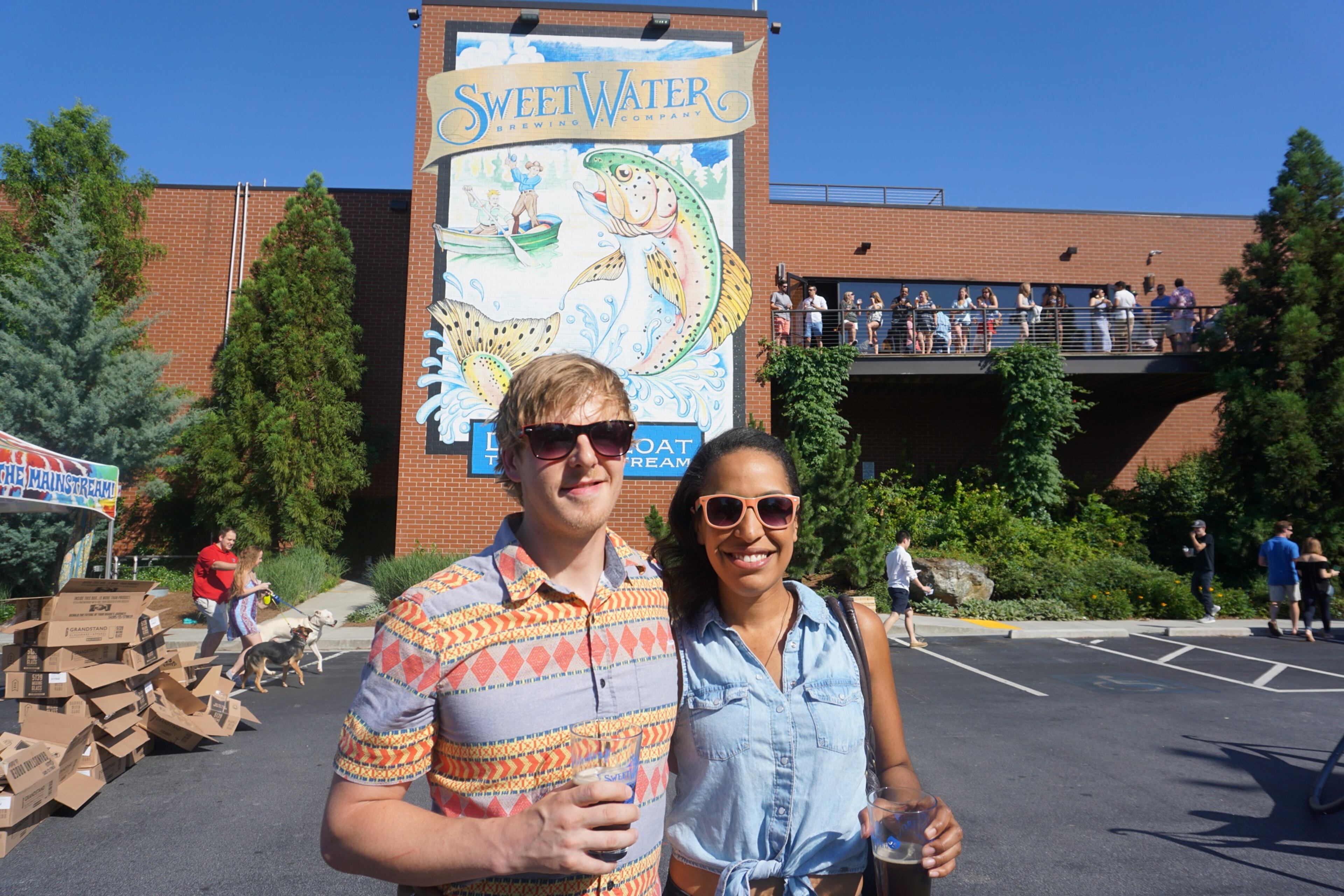 Adam Foster and Hollie Loblack enjoy libations at Sweetwater's I Survived I-85 party, Friday, May 26, 2017.