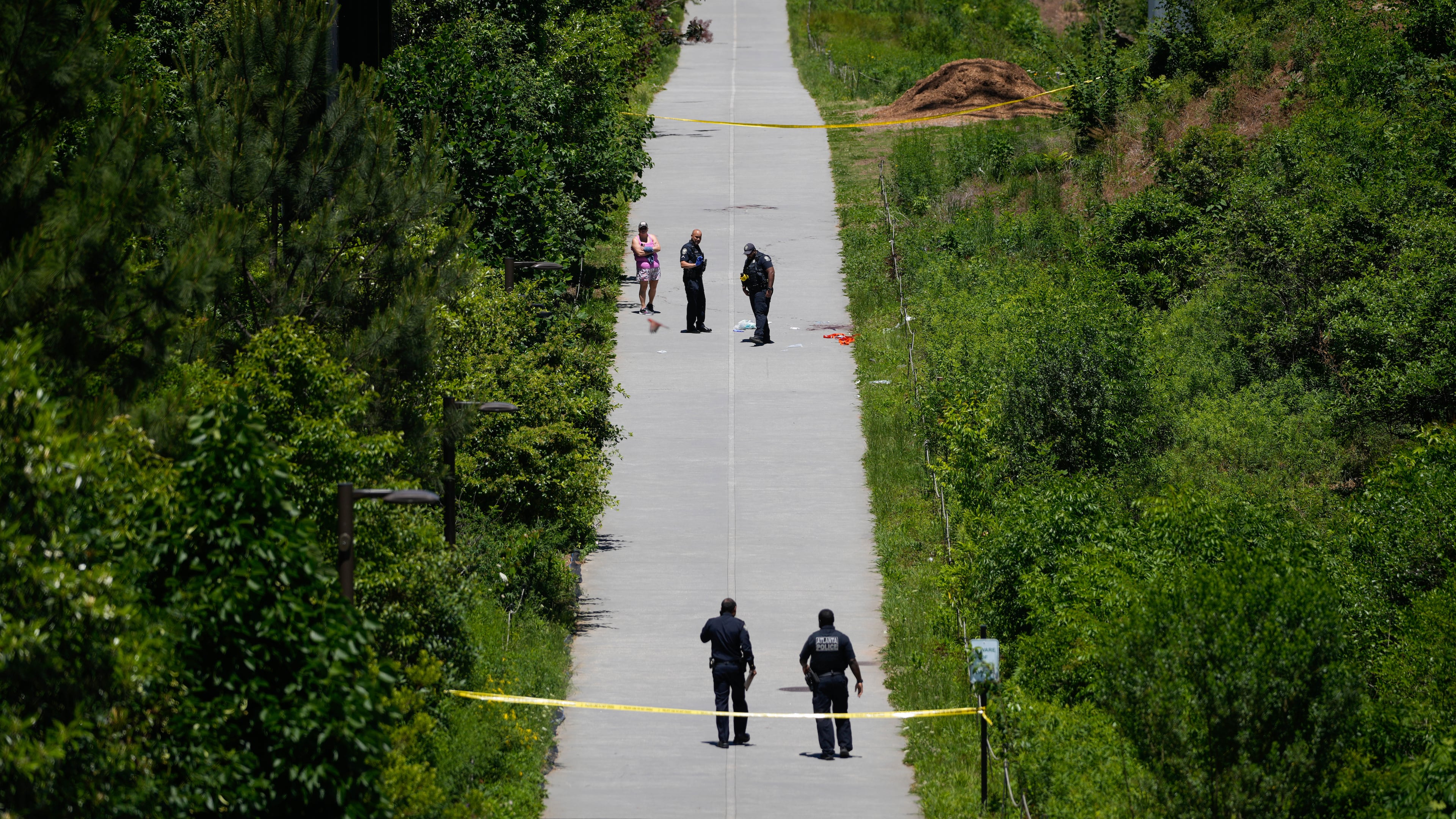 Crime scene tape blocks off a portion of the Beltline near Flagler Avenue Northeast, where Atlanta police say they are responding to a report of a person stabbed. (Ben Hendren for the AJC)