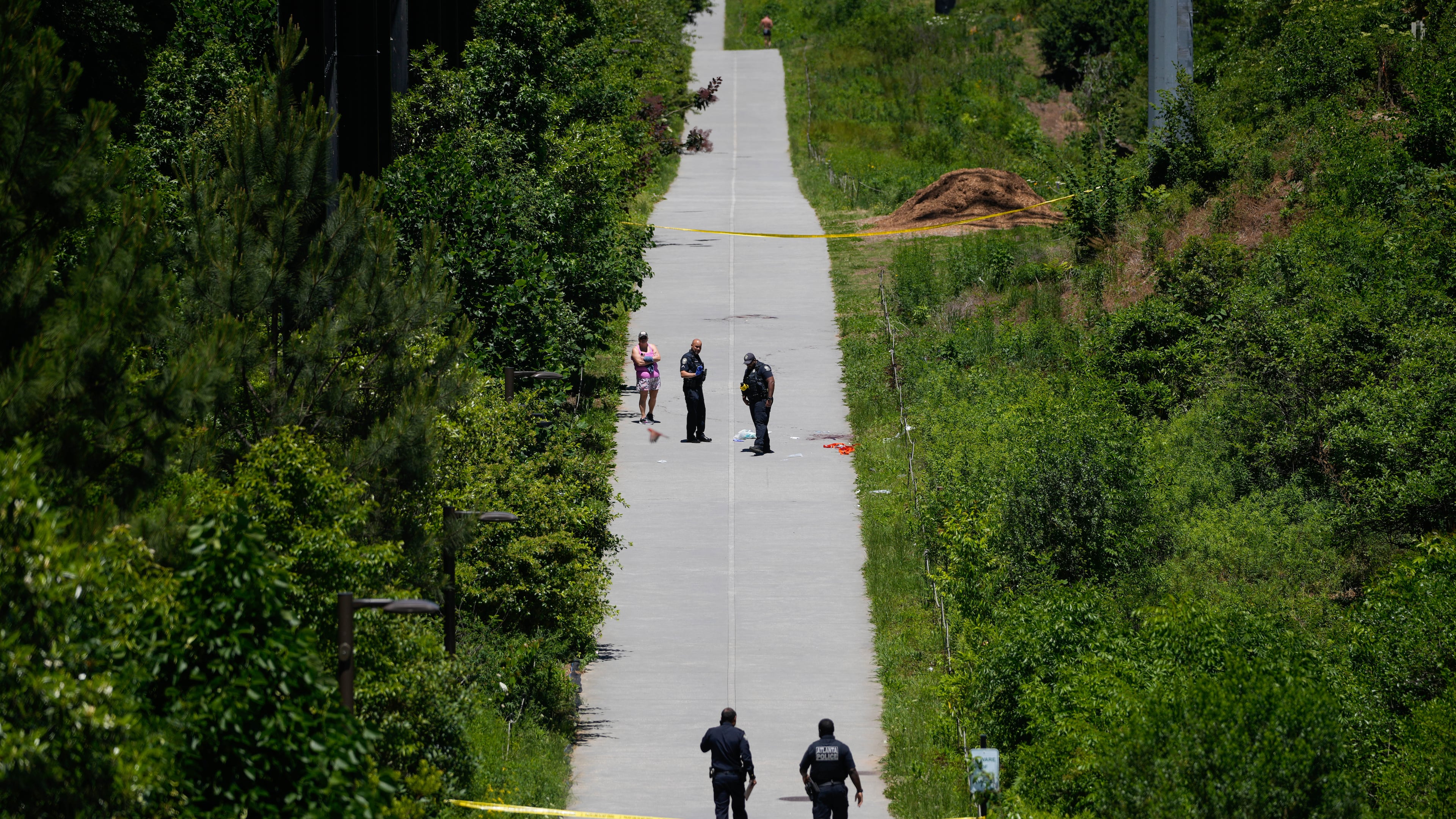 Crime scene tape blocks off a portion of the Beltline near Flagler Avenue Northeast, where Atlanta police say they are responding to a report of a person stabbed. (Ben Hendren for the AJC)
