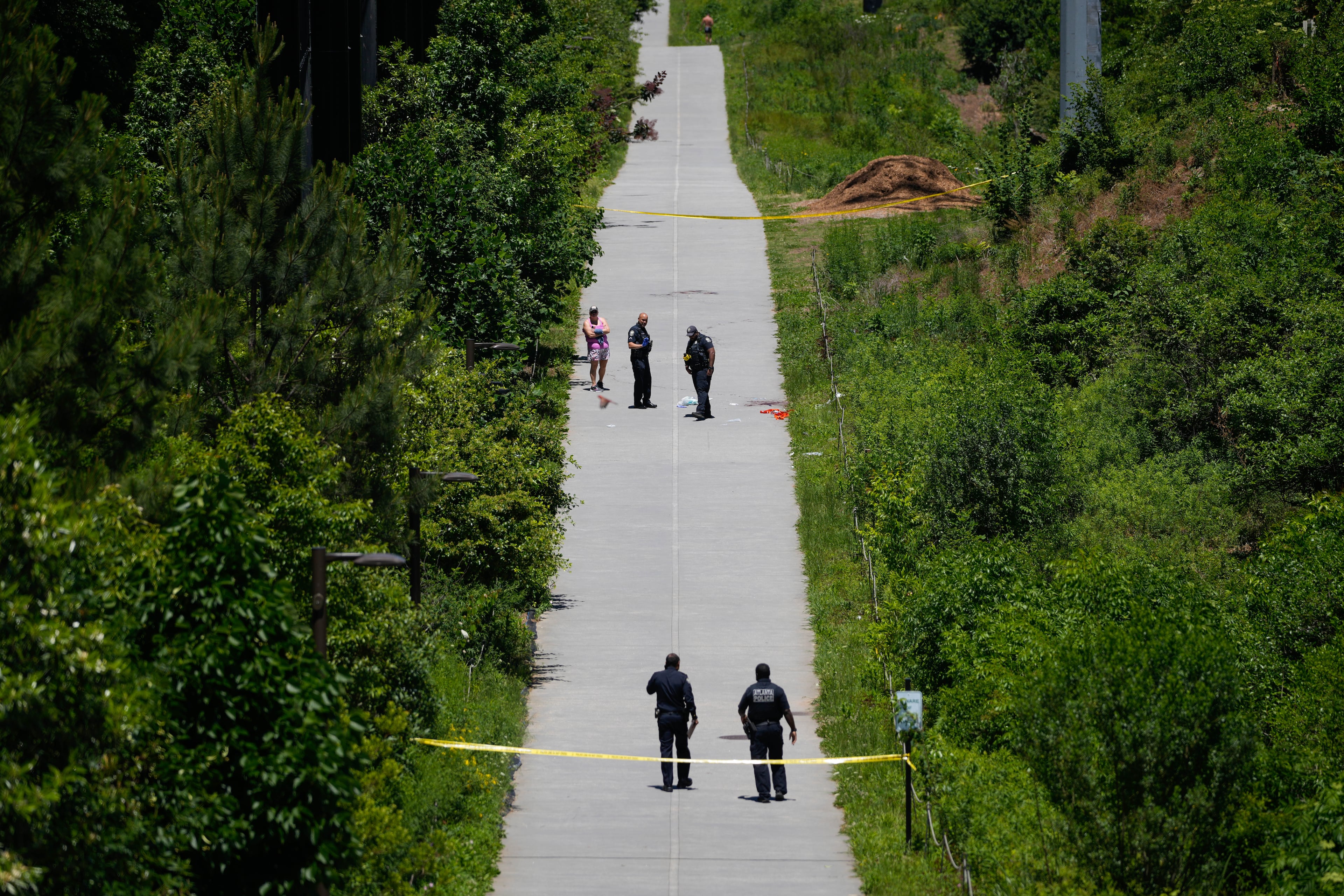 Crime scene tape blocks off a portion of the Beltline near Flagler Avenue Northeast, where Atlanta police say they are responding to a report of a person stabbed. (Ben Hendren for the AJC)