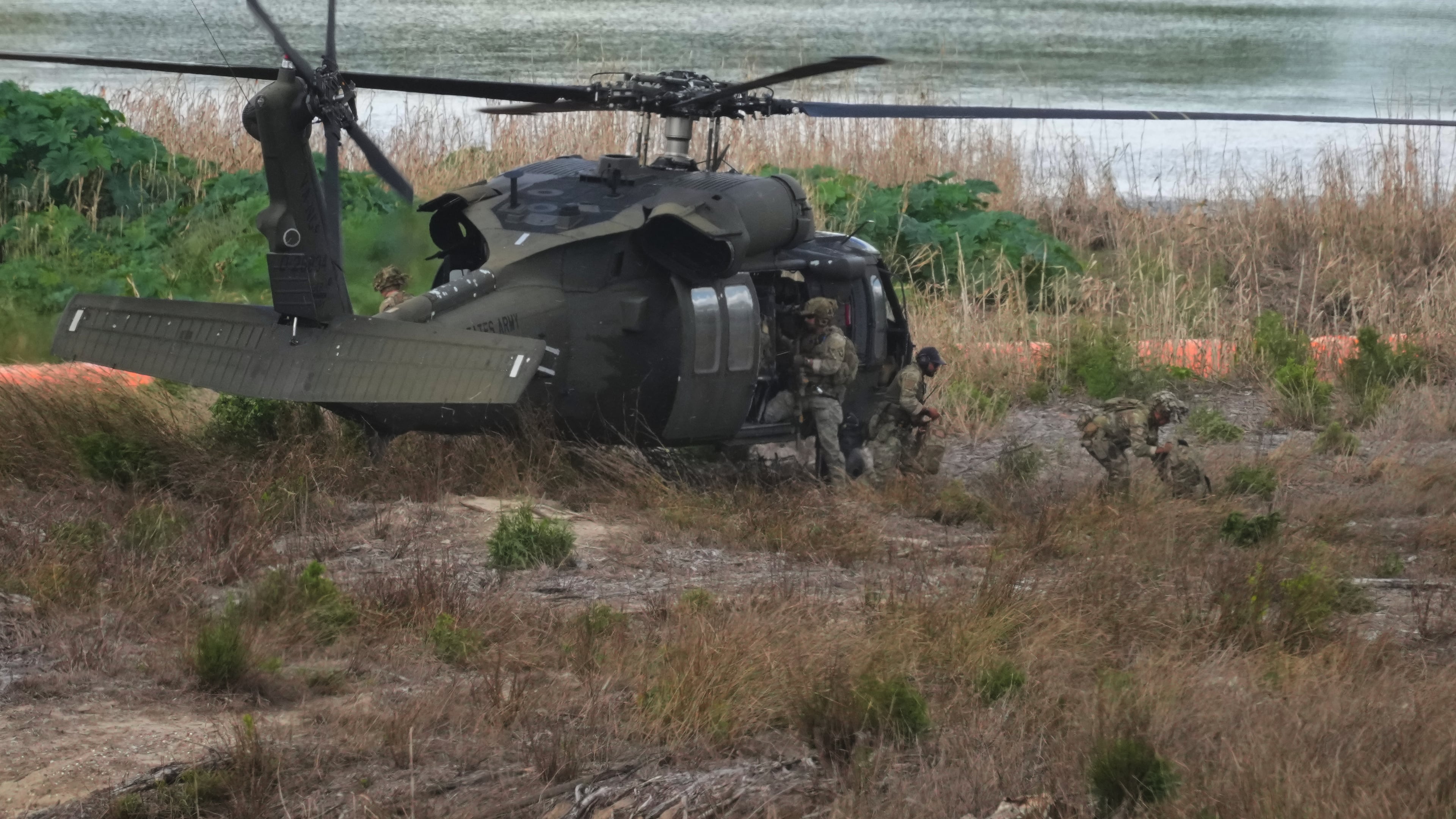 Troops disembark from a U.S. Army helicopter on an island along the Rio Grande in Roma, Texas, Thursday, Oct. 8, 2026. (AP Photo/Eric Gay)
