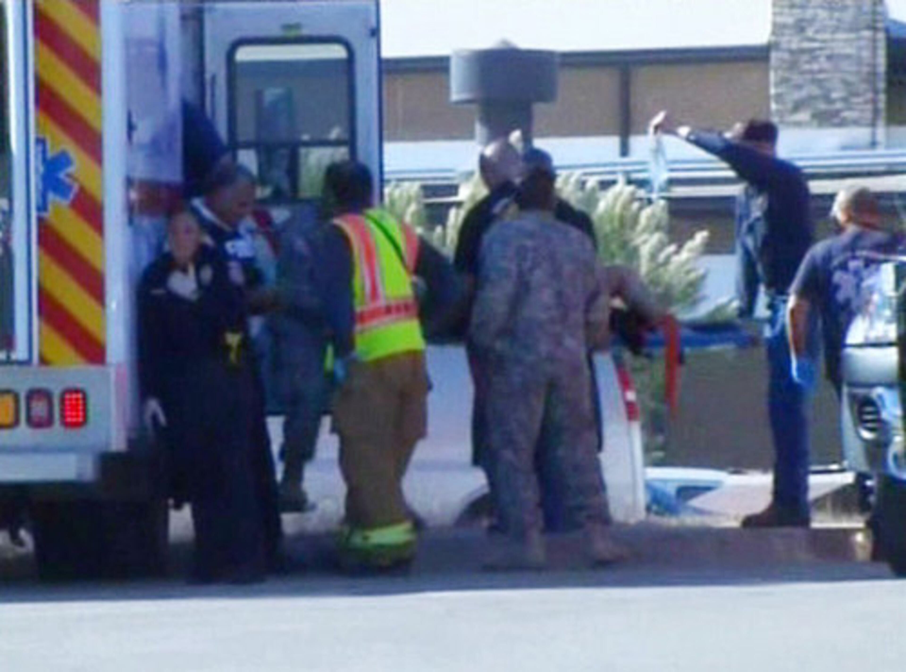 In this image made from Associated Press Television video, emergency personnel take a wounded person on a stretcher to an awaiting ambulance at the scene at the U.S. Army base in Fort Hood.