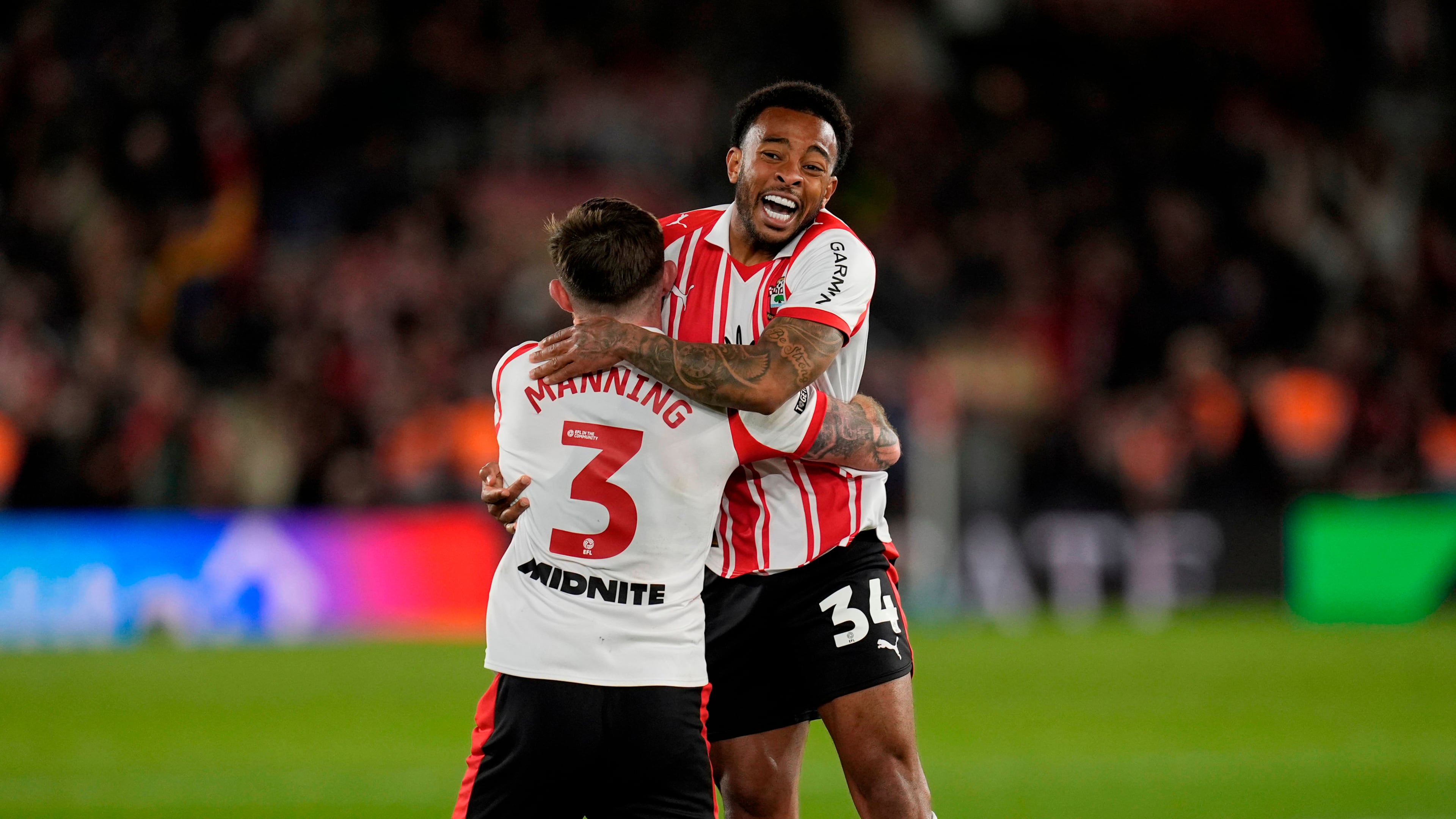 Southampton's Welington, right, and Ryan Manning celebrate at the final whistle in the EFL Championship play off semifinal soccer game between Southampton and Middlesbrough, Tuesday, May 12, 2026, in, Southampton, England. (Andrew Matthews/PA via AP)