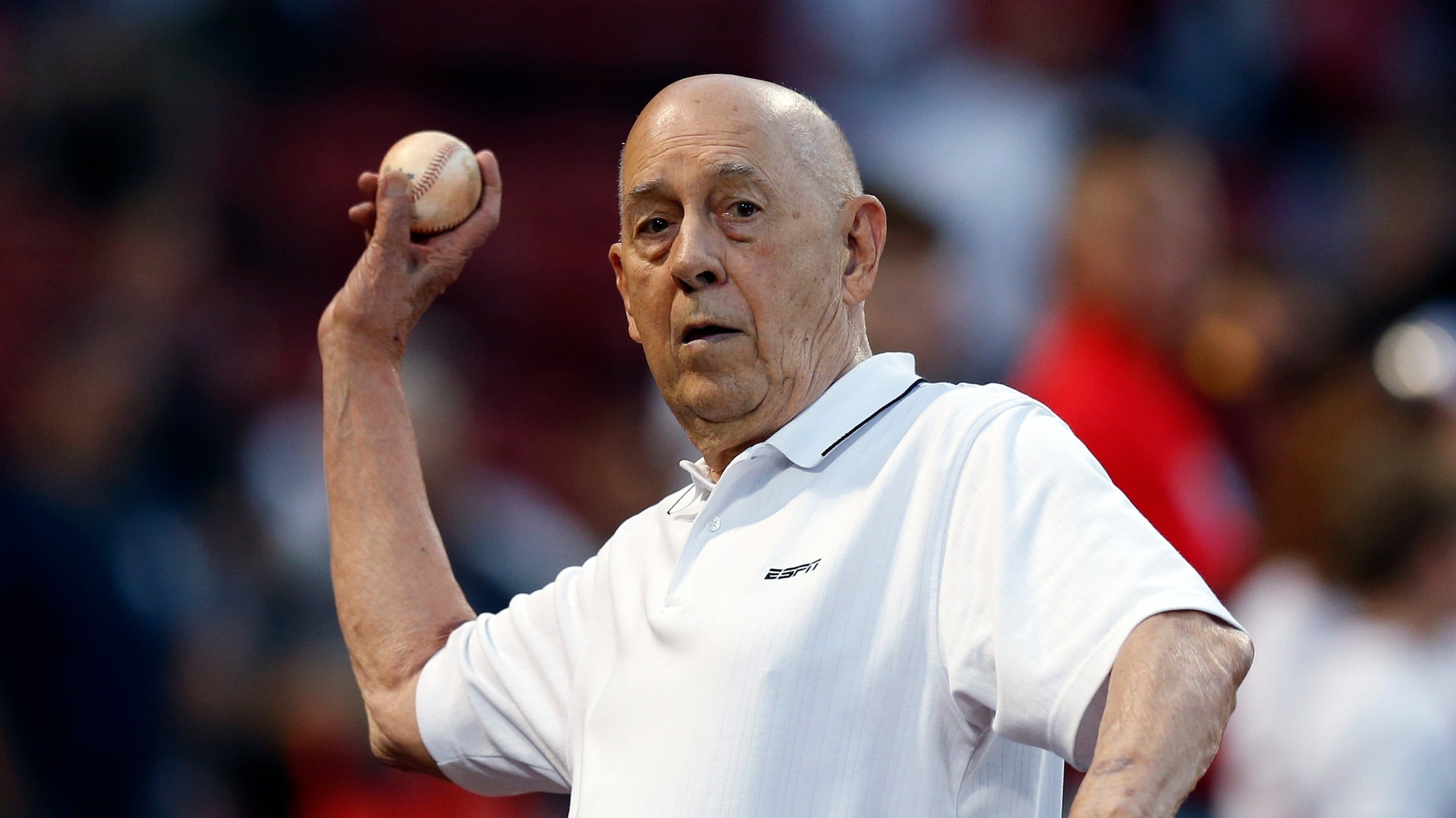 FILE - ESPN co-founder Bill Rasmussen tosses a ball before a baseball game between the Boston Red Sox and the New York Yankees in Boston, Sept. 8, 2019. (AP Photo/Michael Dwyer, File)
