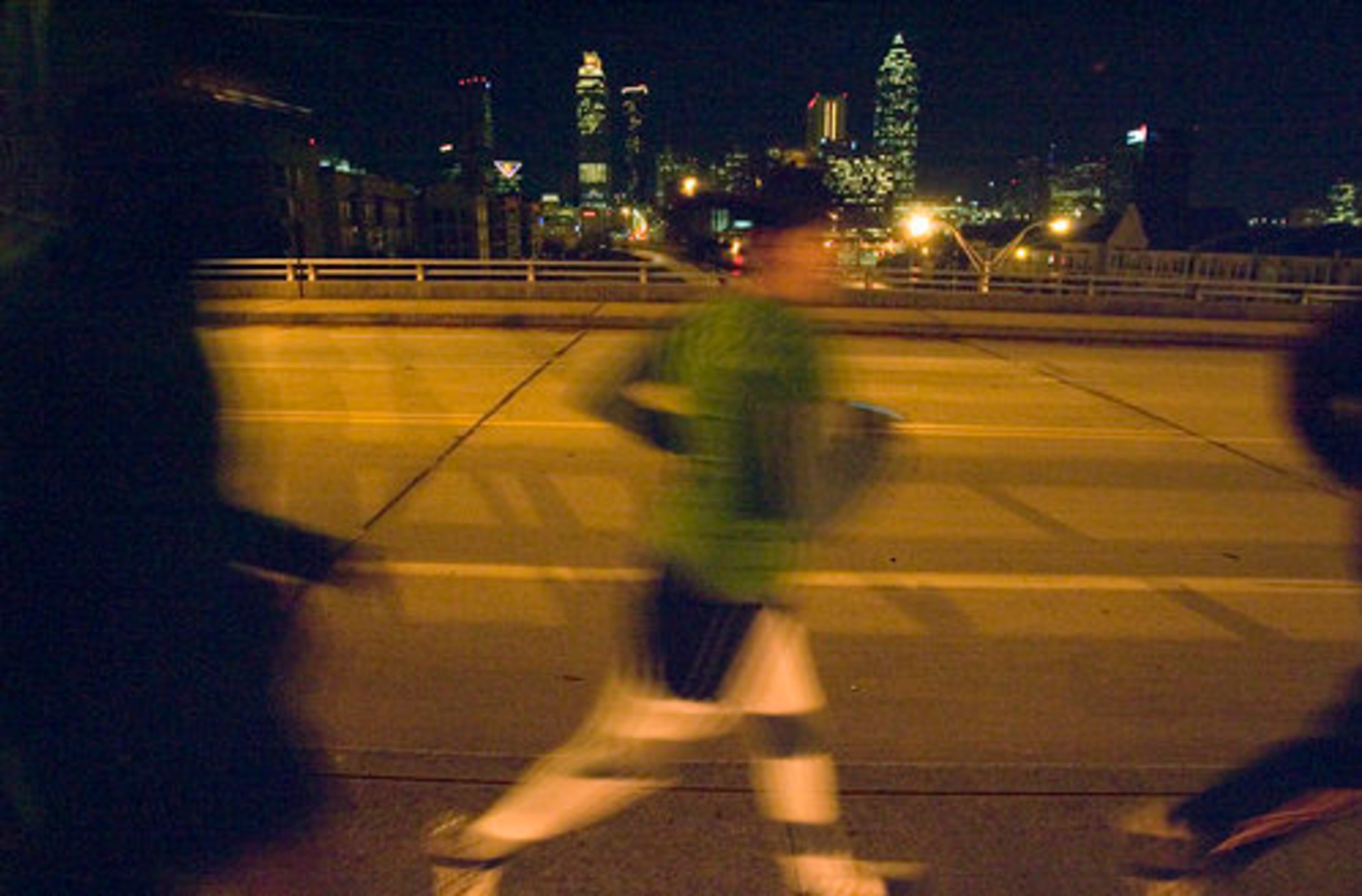 The Tuesday Night Urban Run Club crosses the Jackson Street bridge over Freedom Parkway in Atlanta.