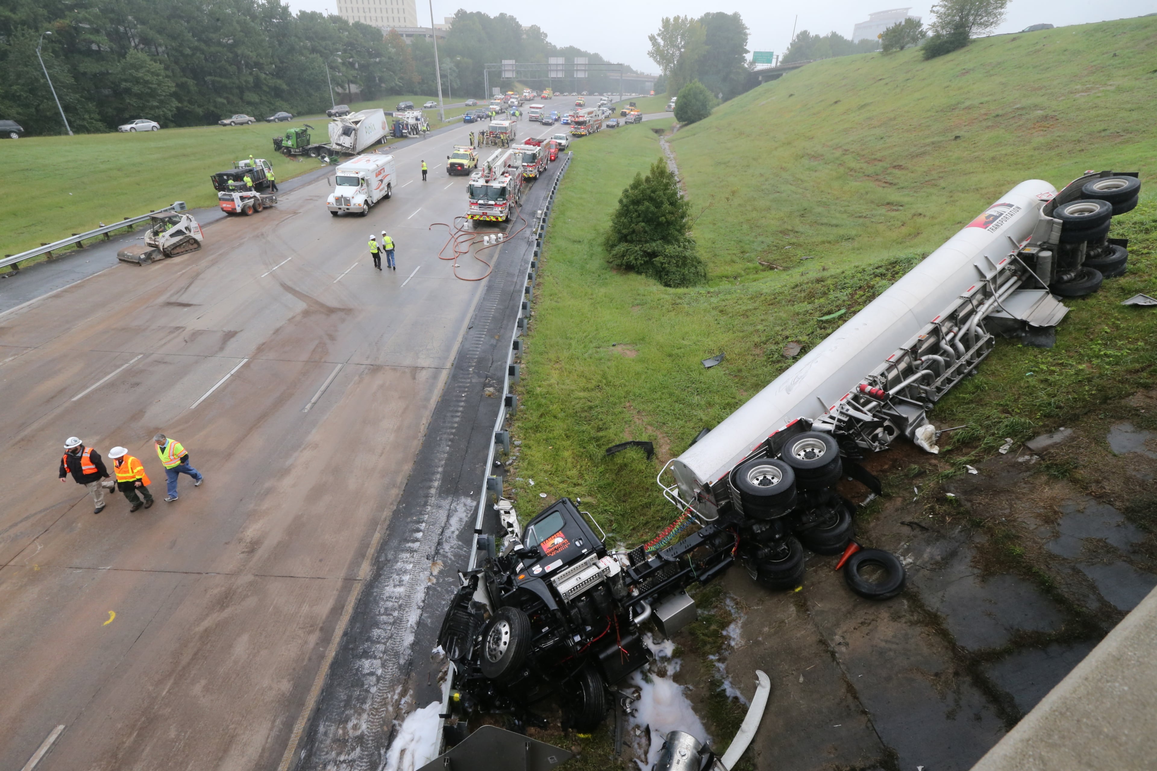One of the busiest interchanges in the state began to re-open in time for the Friday afternoon rush hour. But delays were still heavy more than three hours after two tractor-trailers plunged from I-285 and landed on Ga. 400.