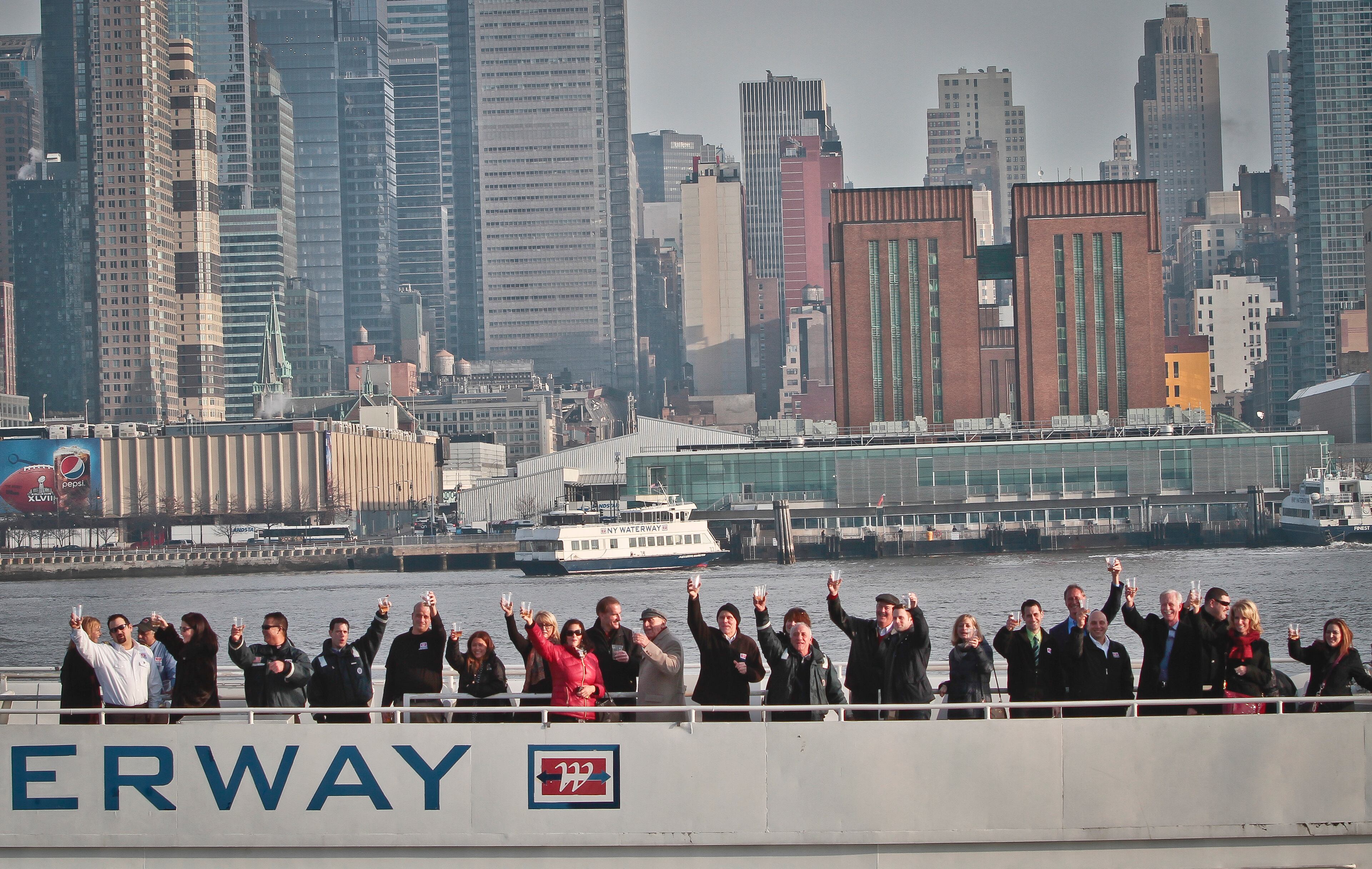 Survivors of U.S. Airways Flight 1549 with 155 passengers and crew, including Captain Chesley "Sully" Sullenberger III, who piloted safe water landing 5 years ago, join with their rescuers in a toast marking the anniversary of the event known as the "miracle on the Hudson," on Wednesday, Jan. 15, 2014 in New York. (AP Photo/Bebeto Matthews)