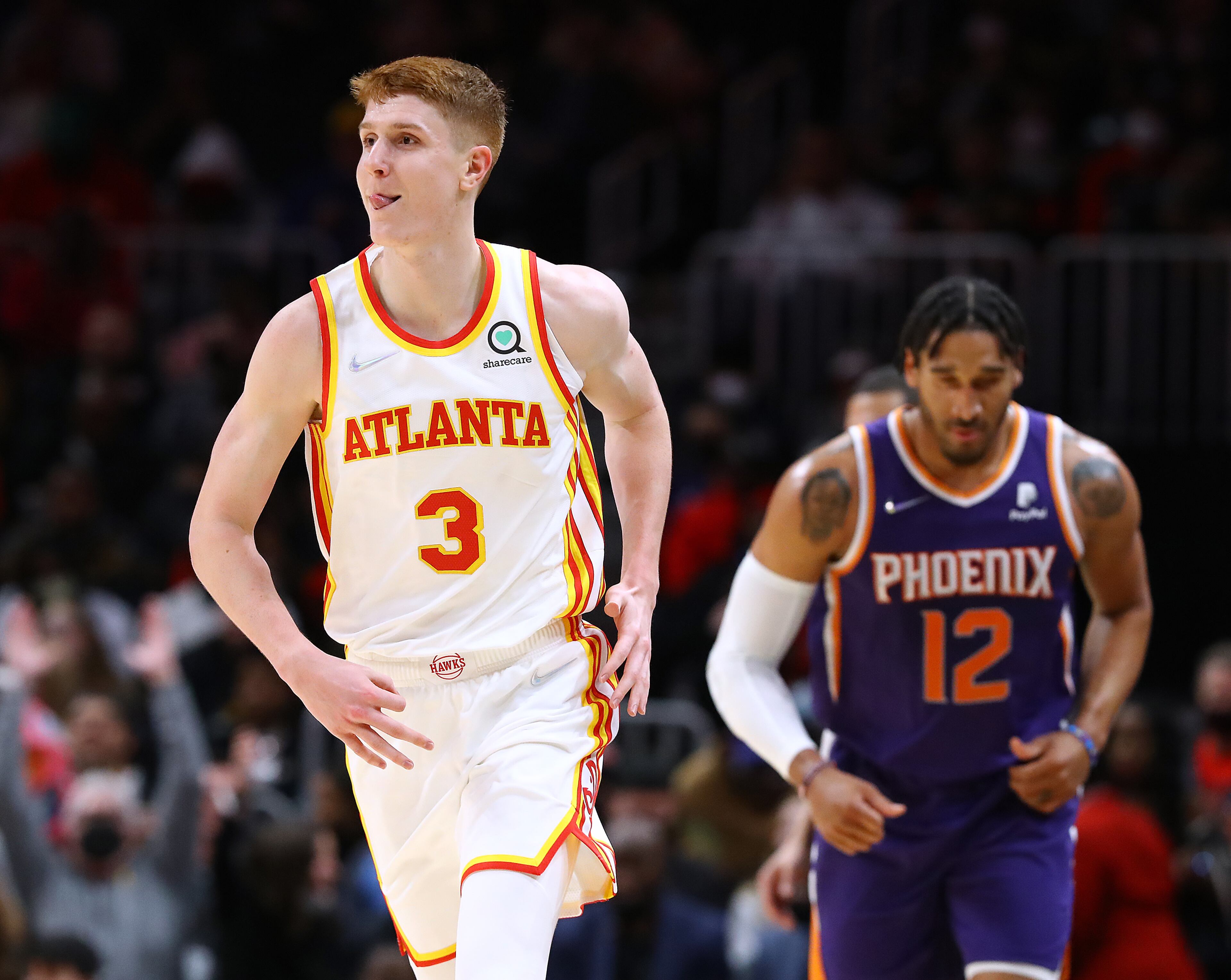 Hawks guard Kevin Huerter reacts to making a three-pointer against Phoenix Suns forward Ish Wainright during the first half of a NBA basketball game on Thursday, Feb. 3, 2022, in Atlanta. “Curtis Compton / Curtis.Compton@ajc.com”`