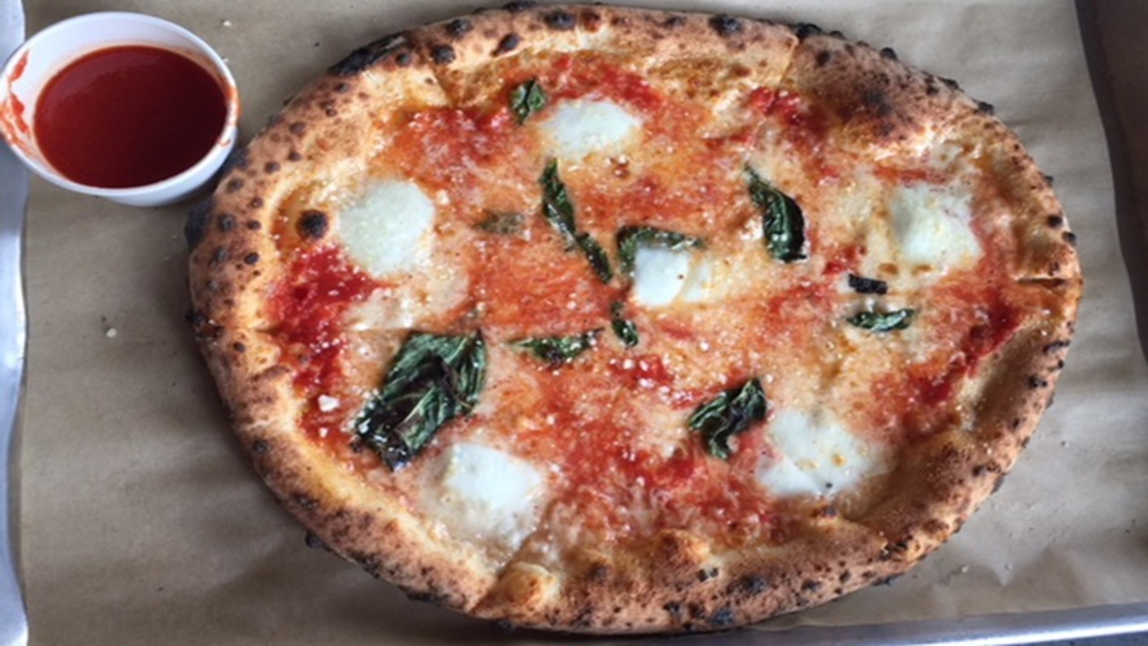 Inizio's version, with a beautifully freckled crust, comes with a little cup of marinara on the side.
(Kathleen Purvis/Charlotte Observer/TNS)