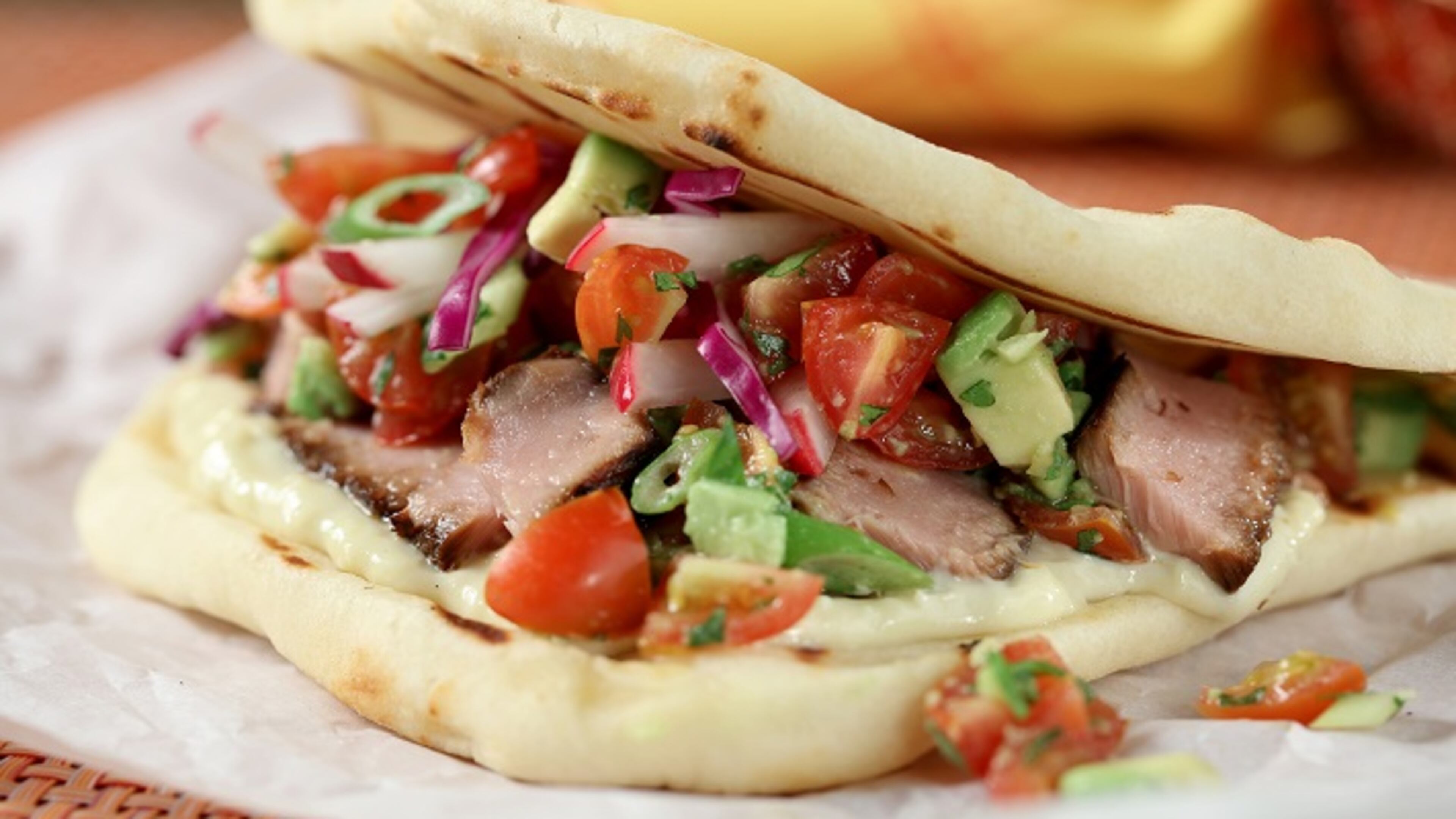 Tuna tacos with sesame wasabi cream and a tomato-avocado salsa taste great on tortillas or on naan, as shown here. (Michael Tercha/Chicago Tribune/TNS)