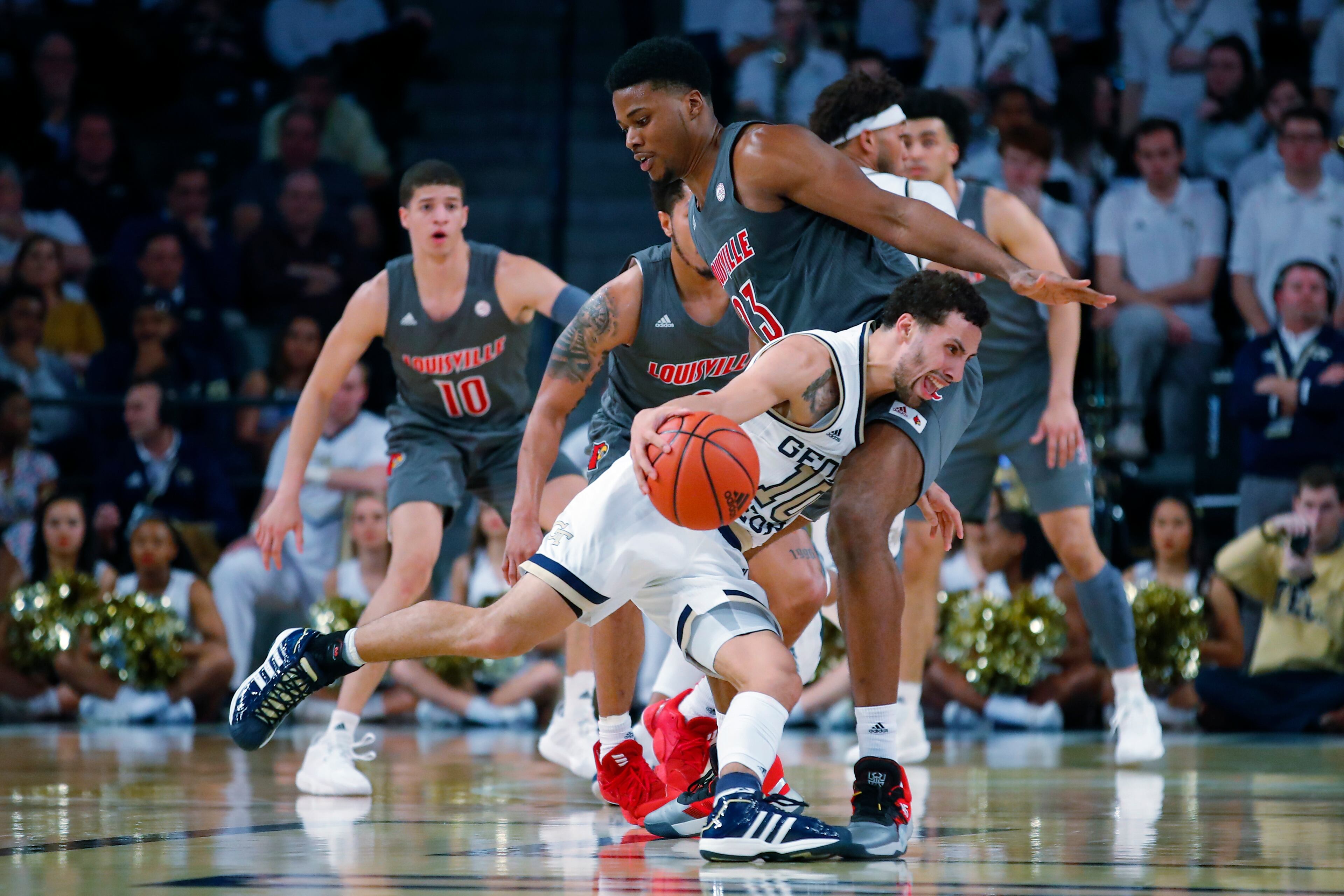 Georgia Tech guard Jose Alvarado (10) drives to the basket against Louisville center Steven Enoch (23) during the first half of an NCAA college basketball game in Atlanta, Wednesday, Feb. 12, 2020. (AP Photo/Todd Kirkland)