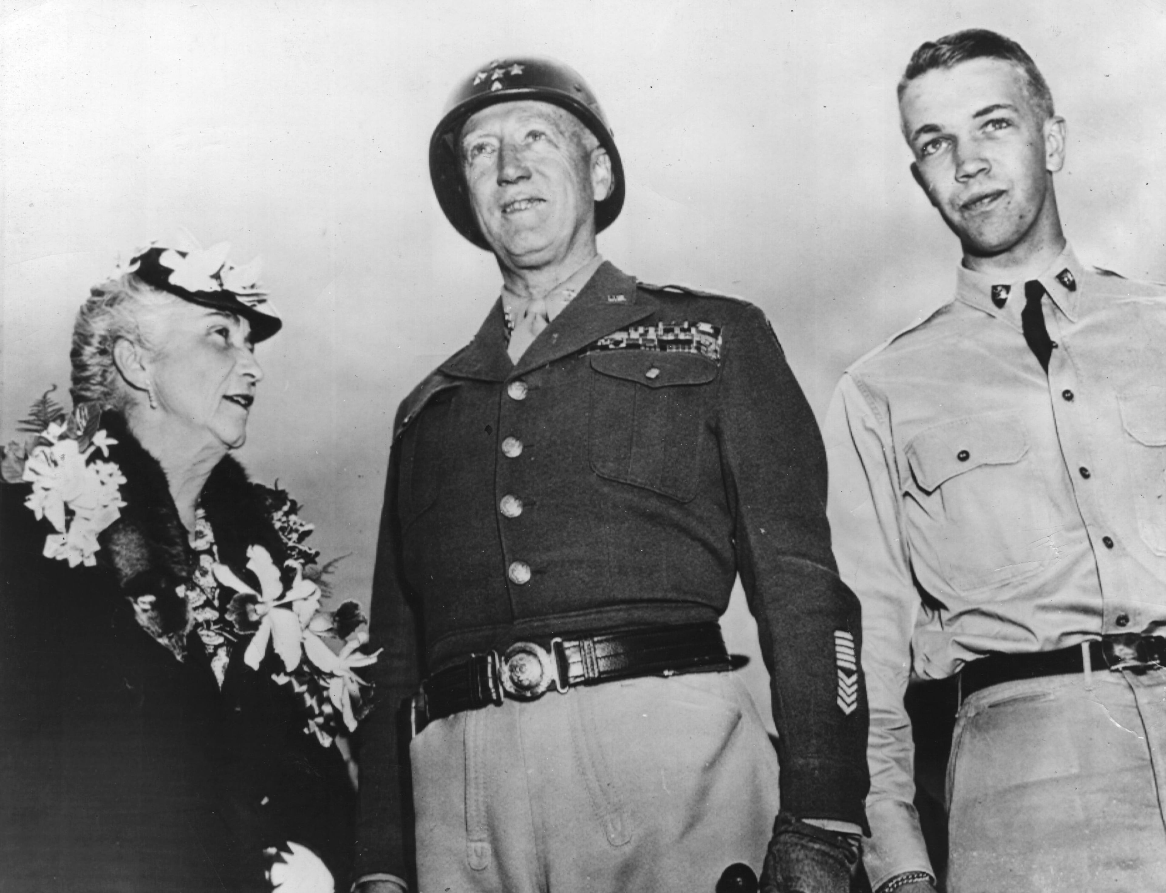 American Gen. George S. Patton Jr. (center, 1885-1945), 'Old Blood & Guts' Commander of US 3rd Army, with his wife, Beatrice, and son George Patton IV (1923-2004), a West Point Cadet, at a family reunion in Bedford, Mass., circa 1945.