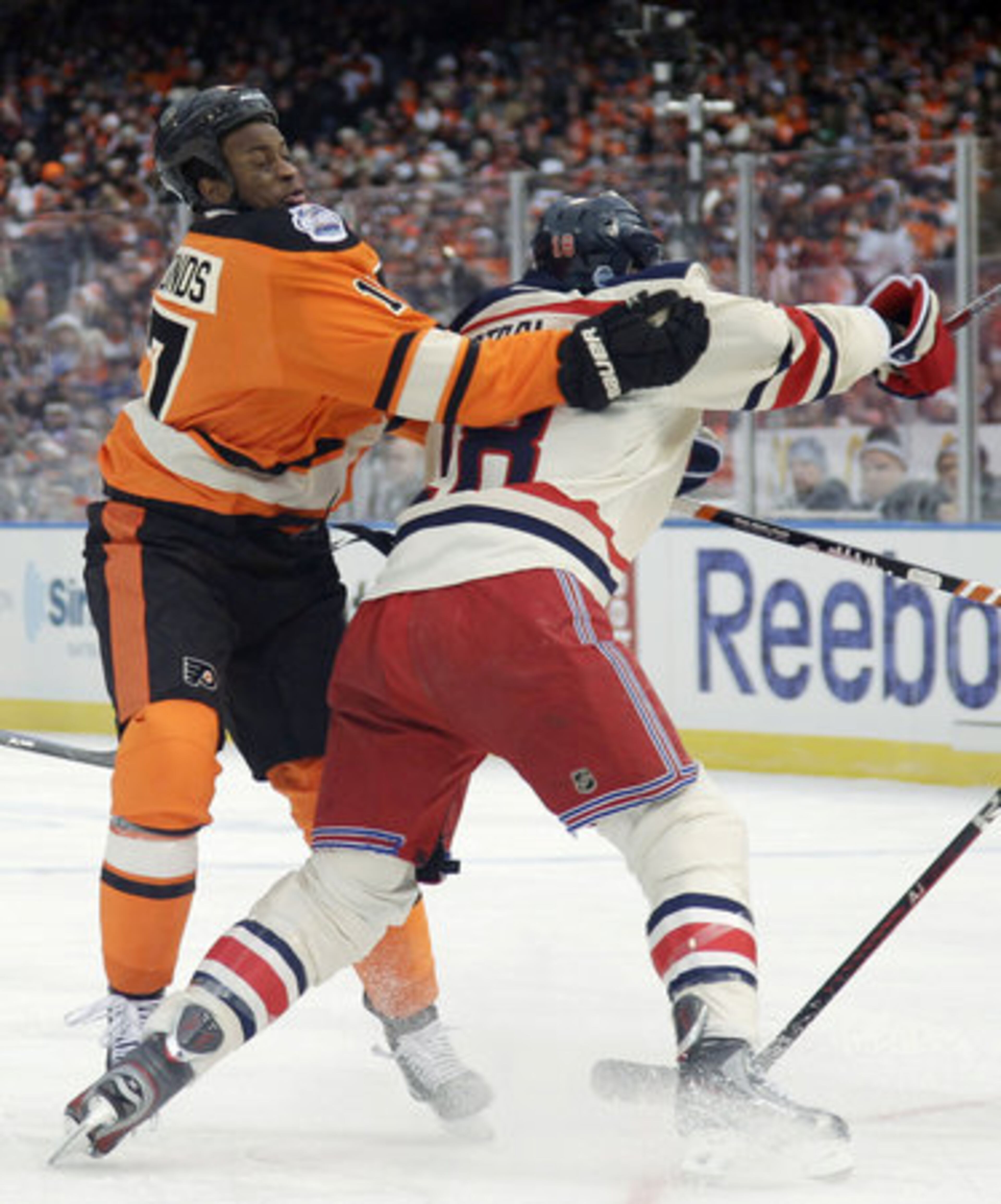 Philadelphia Flyers' Wayne Simmonds, left, and New York Rangers' Marc Staal collide in the first period of the NHL Winter Classic hockey game, Monday, Jan. 2, 2012, in Philadelphia.