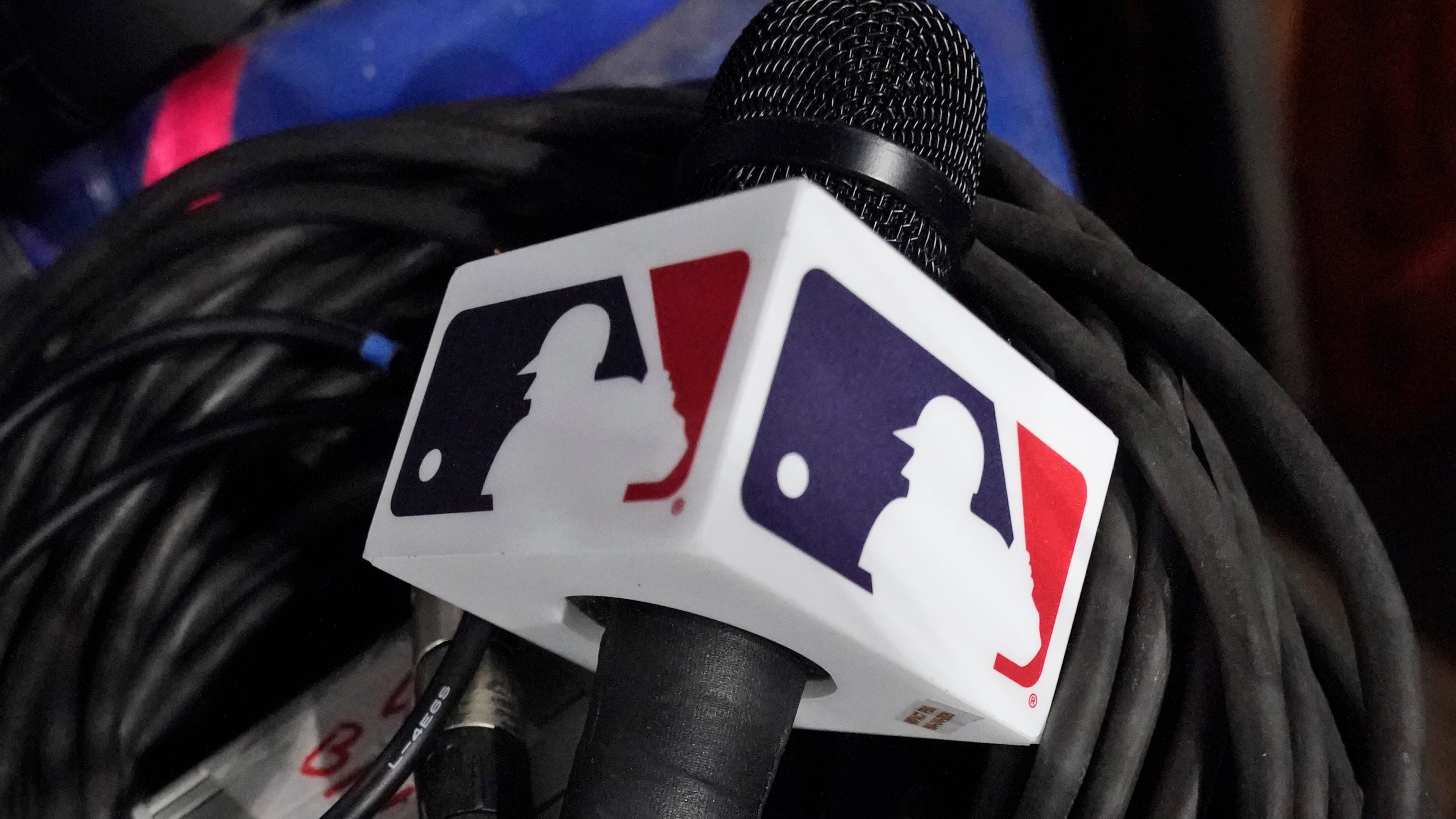 A microphone belonging to a field reporter for the San Diego Padres sits on top of audio cables during a baseball game between the Miami Marlins and the Padres, May 31, 2023, in Miami. (AP Photo/Wilfredo Lee, File)