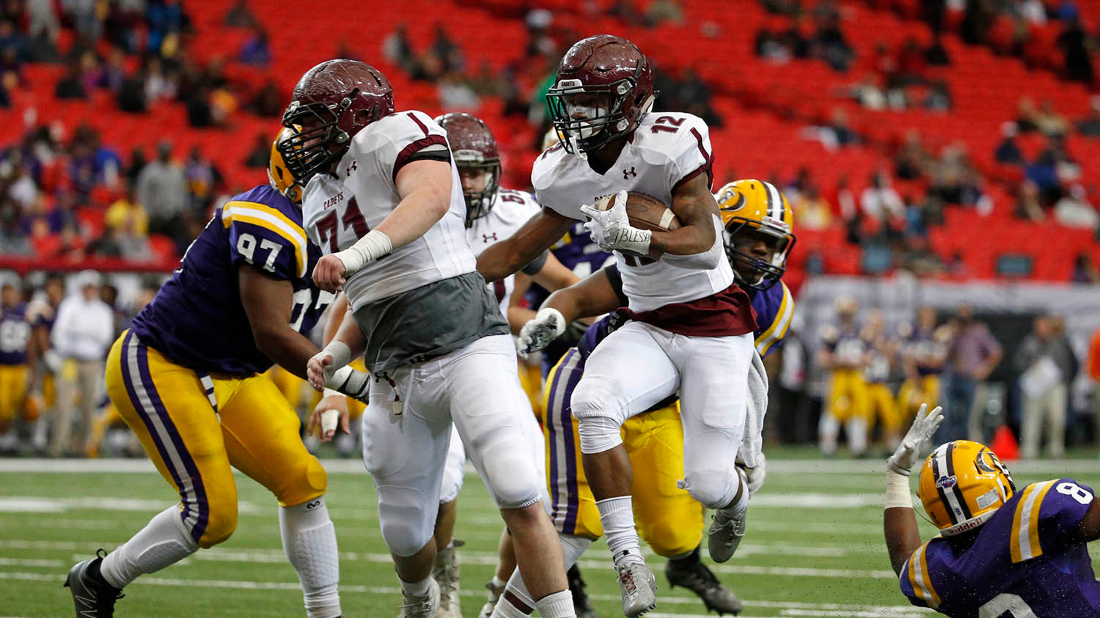 Benedictine running back John Wesley Kennedy III (12) rushes for a touchdown run in the first half of the Class AA state championship game Saturday at the Georgia Dome against Fitzgerald. (Jason Getz for the AJC)