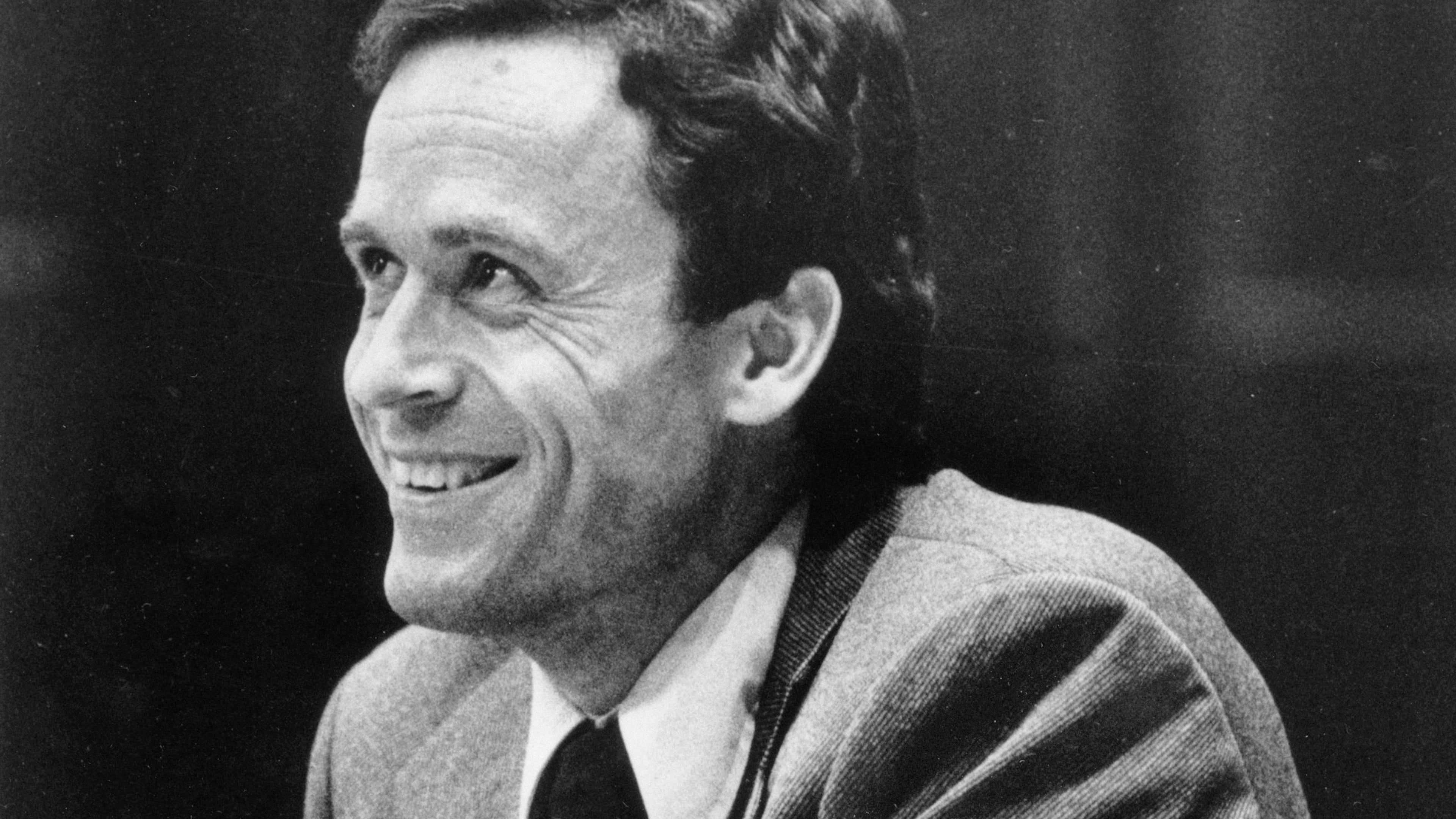 FILE - Ted Bundy smiles during the second day of jury selection for his murder trial in a Dade County courtroom in Miami, June 27, 1979. (AP Photo, Pool, File)