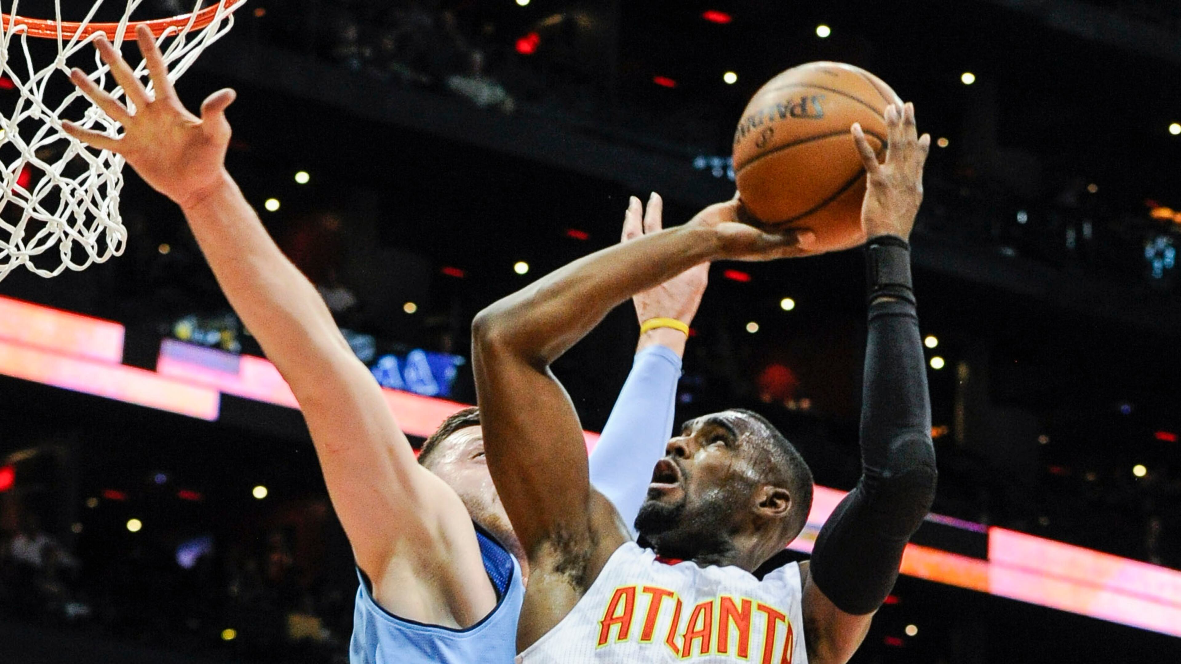 Atlanta Hawks guard Tim Hardaway Jr. (10) goes to the basket against the defense of Denver Nuggets center Jusuf Nurkic, of Bosnia, during the first half of an NBA basketball game, Thursday, March 17, 2016, in Atlanta. (AP Photo/John Amis)