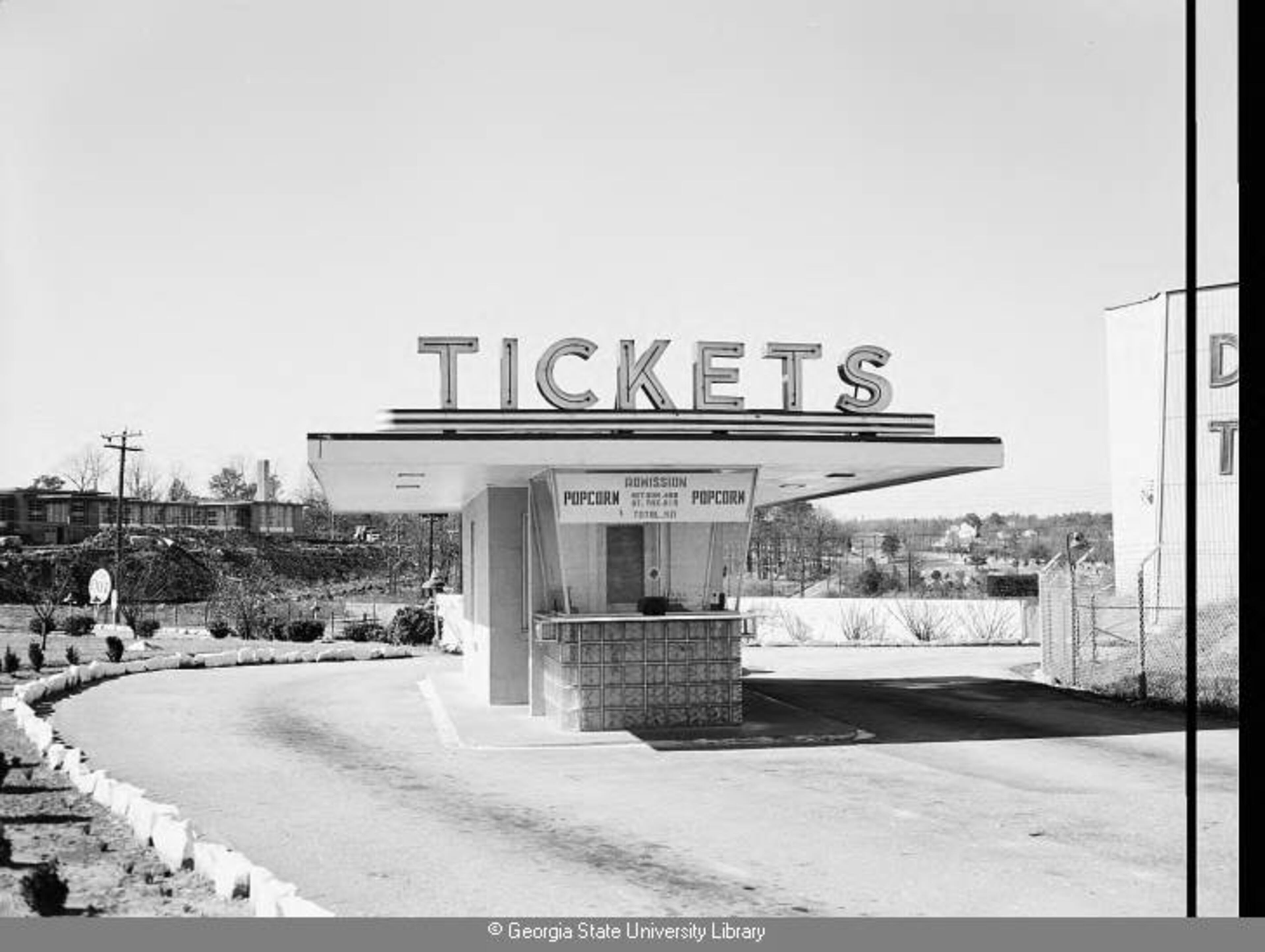 1956 -- The Stewart Drive-In ticket booth. Cleveland Avenue and the Stewart Avenue (later Emma Hutchinson) School are visible in the background. LANE BROS. PHOTOGRAPHS / GSU