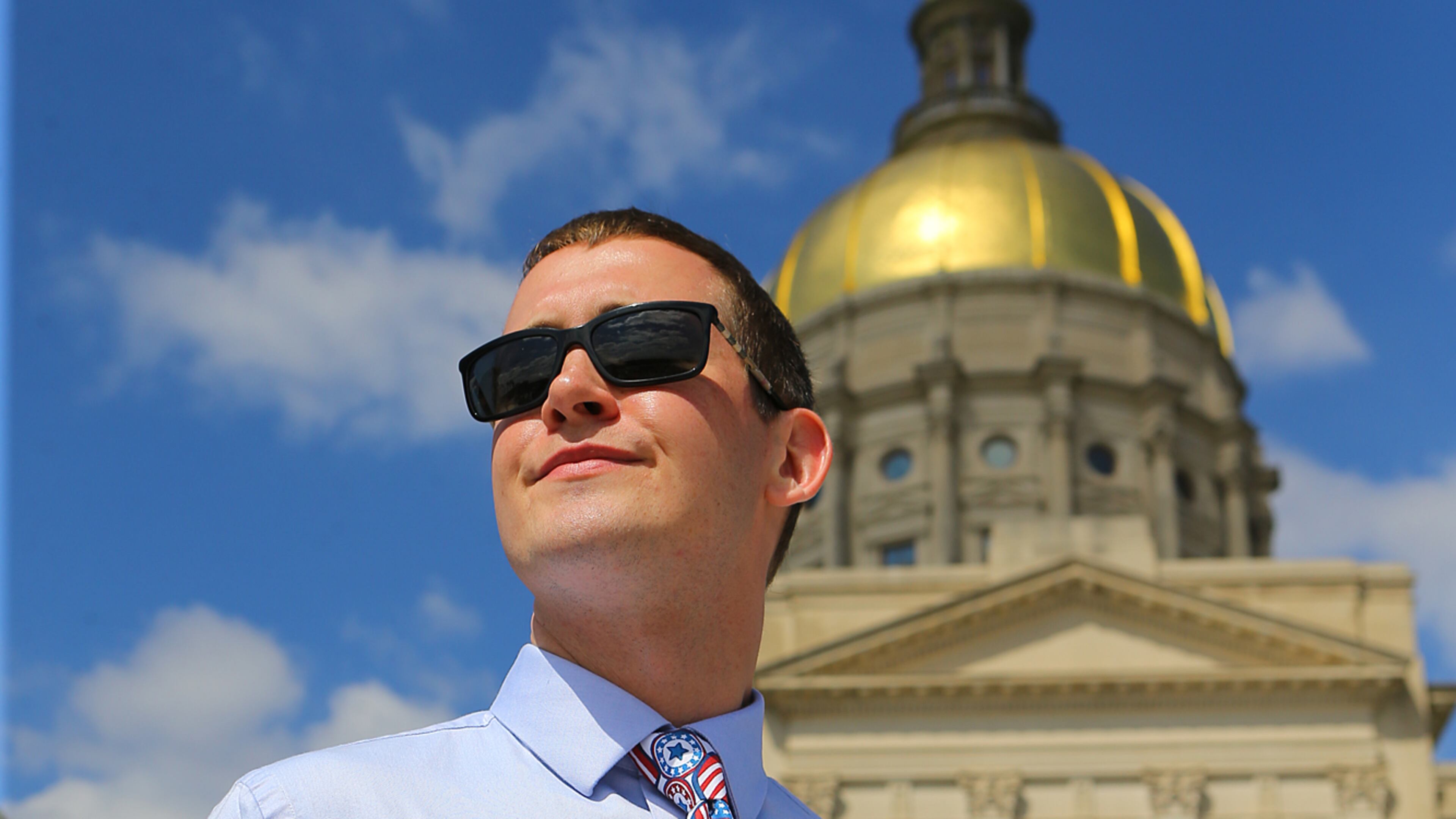 031715 ATLANTA: David Bachman holds a sign after speaking during a rally at the Capitol against SB 129, the "license to discriminate" legislation pushed by Sen. Josh McKoon and Rep. Sam Teasley on Tuesday, March 17, 2015, at Liberty Plaza in Atlanta. Curtis Compton / ccompton@ajc.com David Bachman, a young Republican business owner, spoke against S.B. 129. Curtis Compton/ccompton@ajc.com
