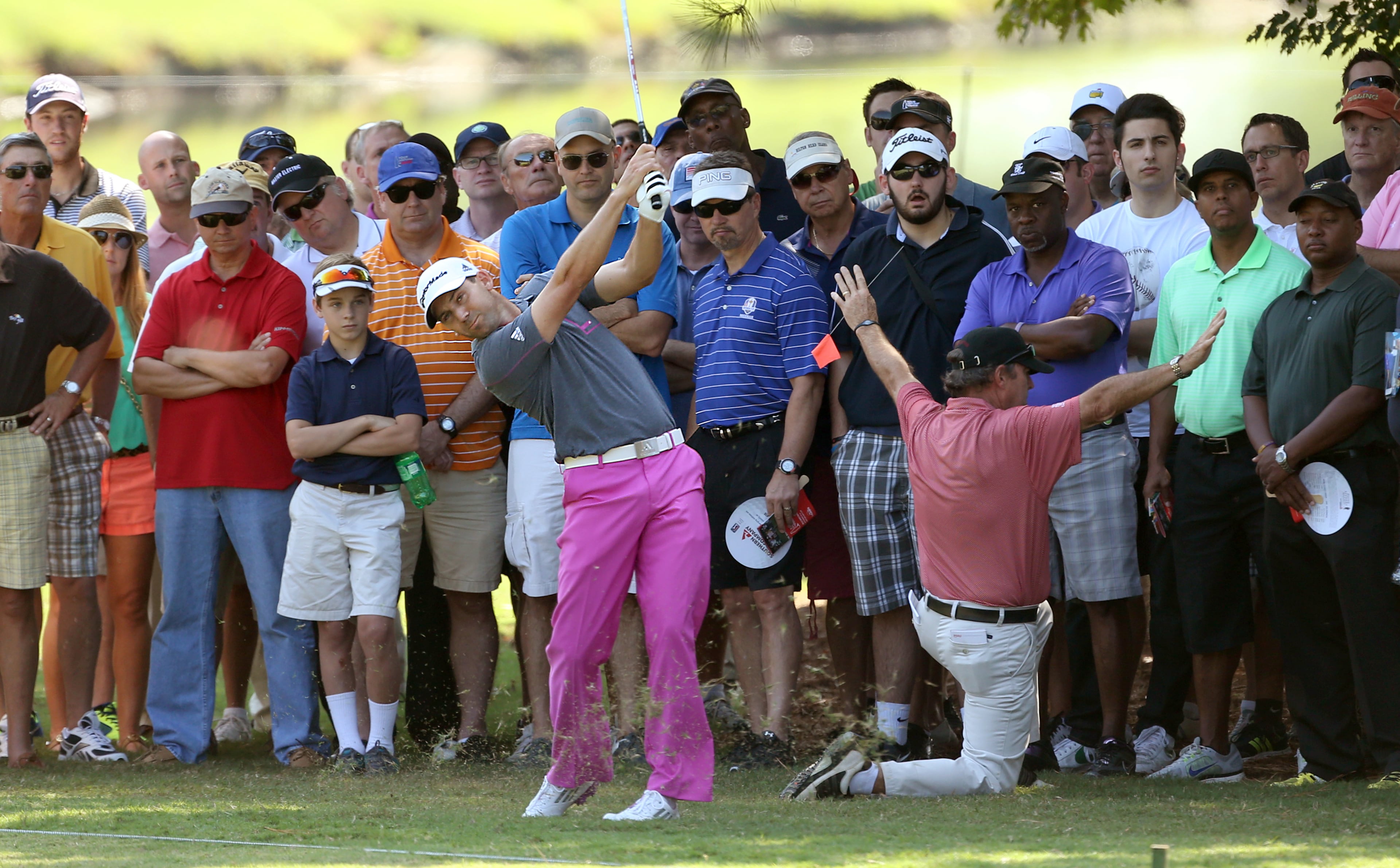 Near spectators, Sergio Garcia follows through on his second shot on the No. 1 fairway during round one of the 2013 Tour Championship at East Lake Golf Club Thursday morning in Atlanta, Ga., September 19, 2013. Garcia finished tied for 6th with a round of 2 under par.