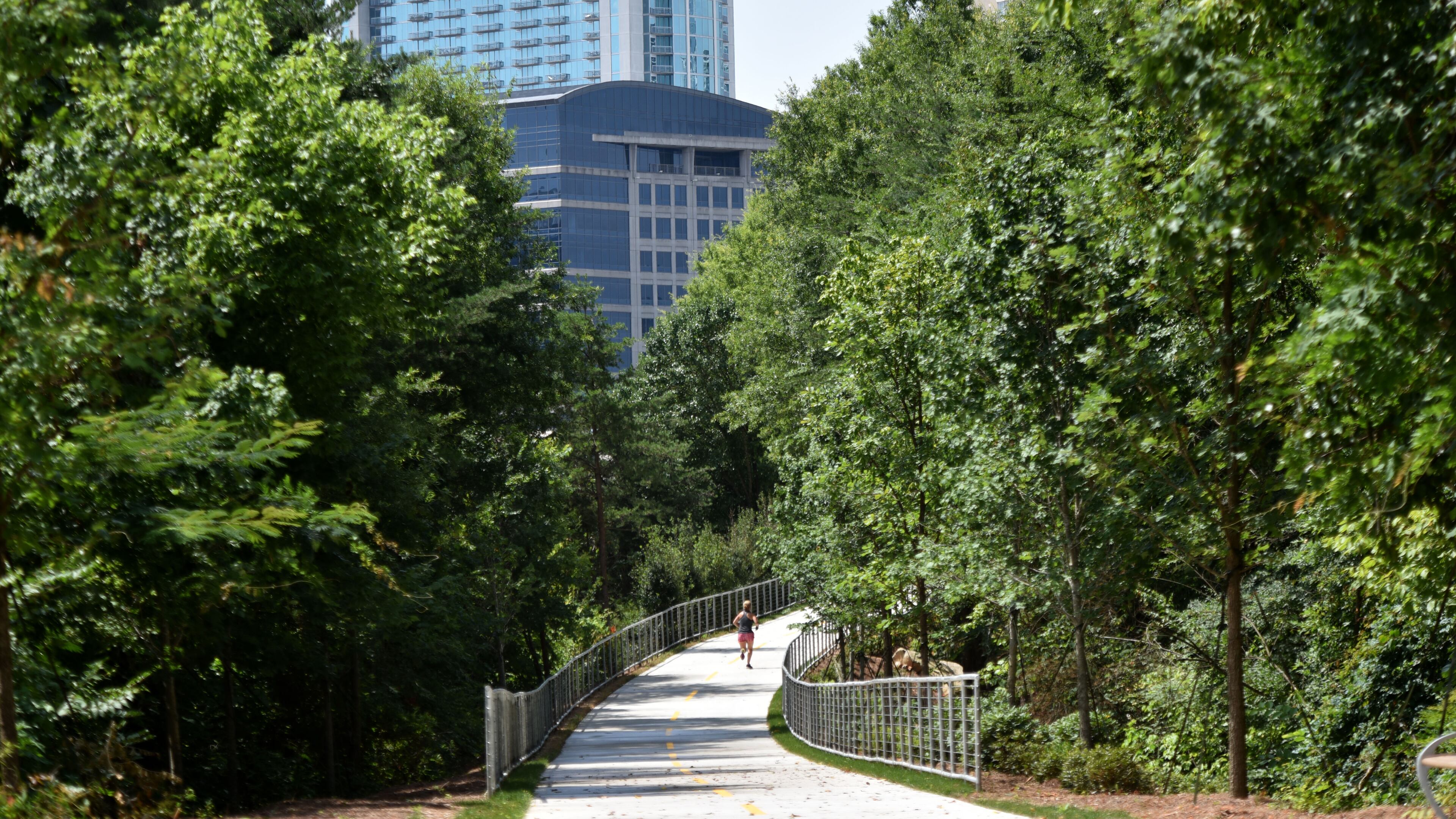A woman jogs on PATH 400 on Thursday, July 2, 2015. Phase I of PATH 400, which opened in January, is a half-mile stretch of multi-use path that connects Lenox Road at Tower Place with Old Ivy Road. Georgia is one of only two states without a statewide trail organization, but all that is changing fast. There's a new impetus behind building a coalition from the many different groups who use trails for equestrian activities, mountain-biking, bicycling and walking and joining forces to complete a statewide trail network. After the second annual Georgia Trail Summit was held in Athens last month, this group decided to pursue incorporation into a nonprofit. HYOSUB SHIN / HSHIN@AJC.COM