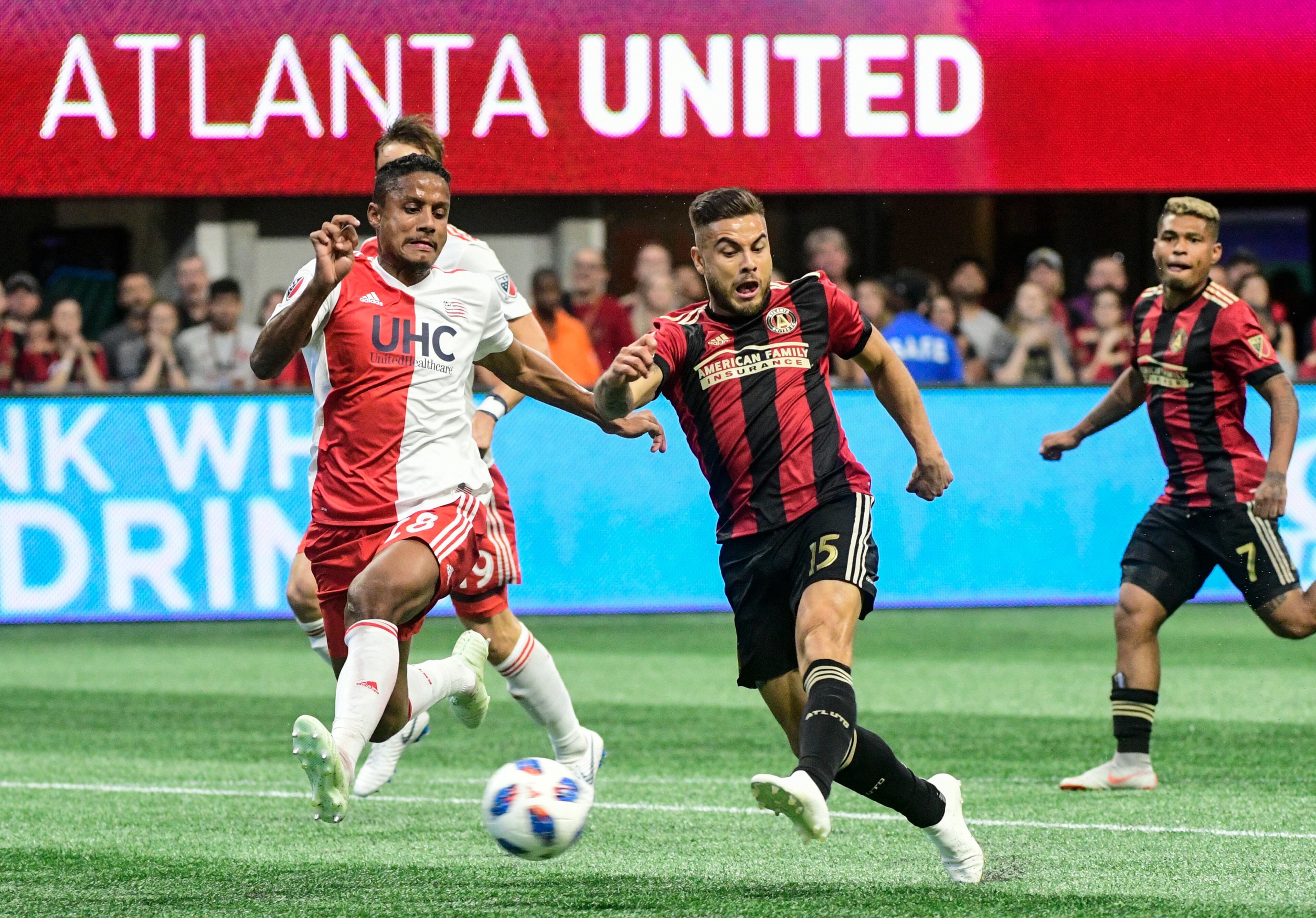 Atlanta United forward Hector Villalba (15) kicks as New England Revolution goalkeeper Brad Knighton (18) defends during the first half of an MLS soccer game, Saturday, Oct. 6, 2018. (John Amis)