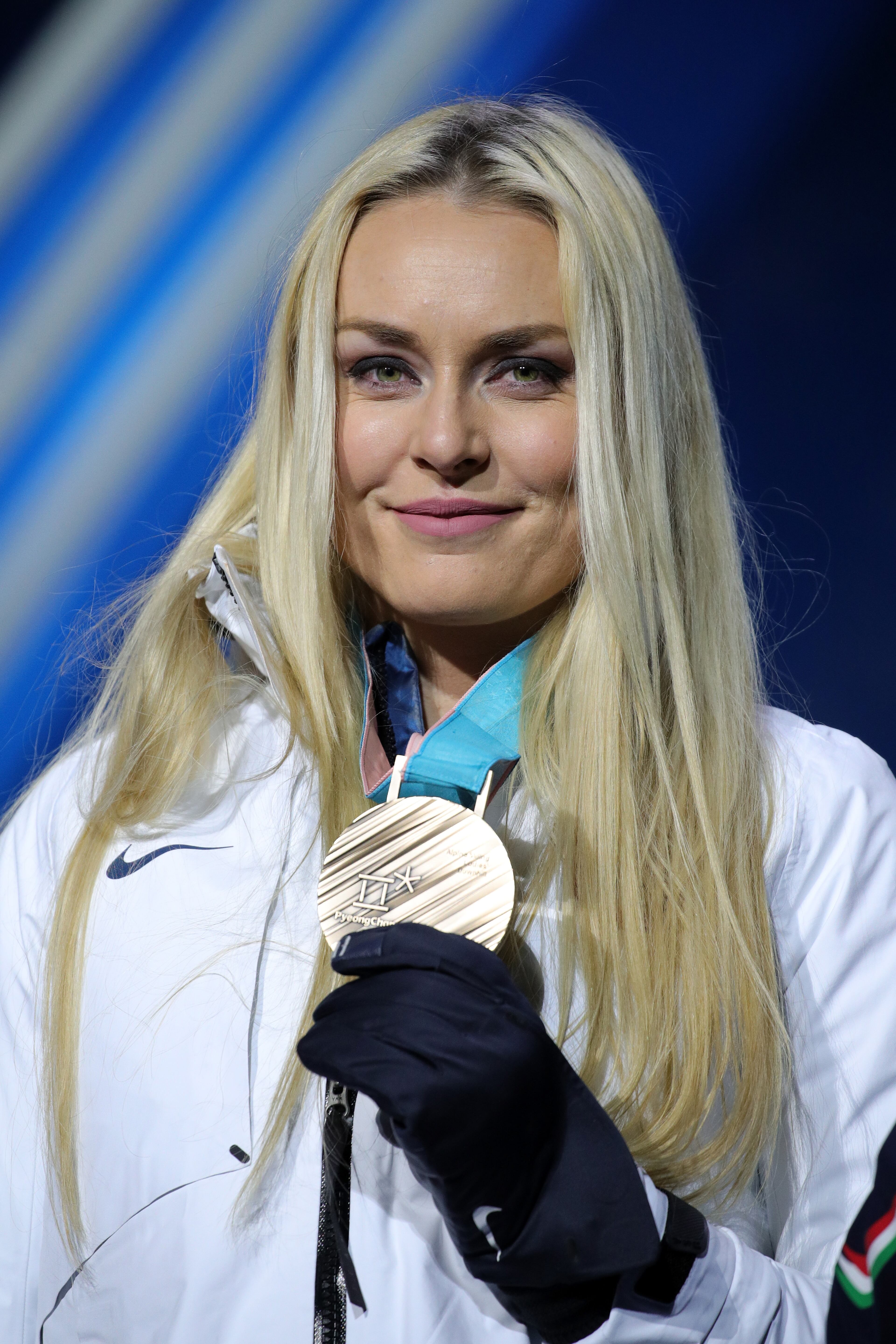 PYEONGCHANG-GUN, SOUTH KOREA - FEBRUARY 21: Bronze medallist Lindsey Vonn of the United States celebrates during the medal ceremony for the Ladies' Downhill on day twelve of the PyeongChang 2018 Winter Olympic Games at Medal Plaza on February 21, 2018 in Pyeongchang-gun, South Korea. (Photo by Andreas Rentz/Getty Images)