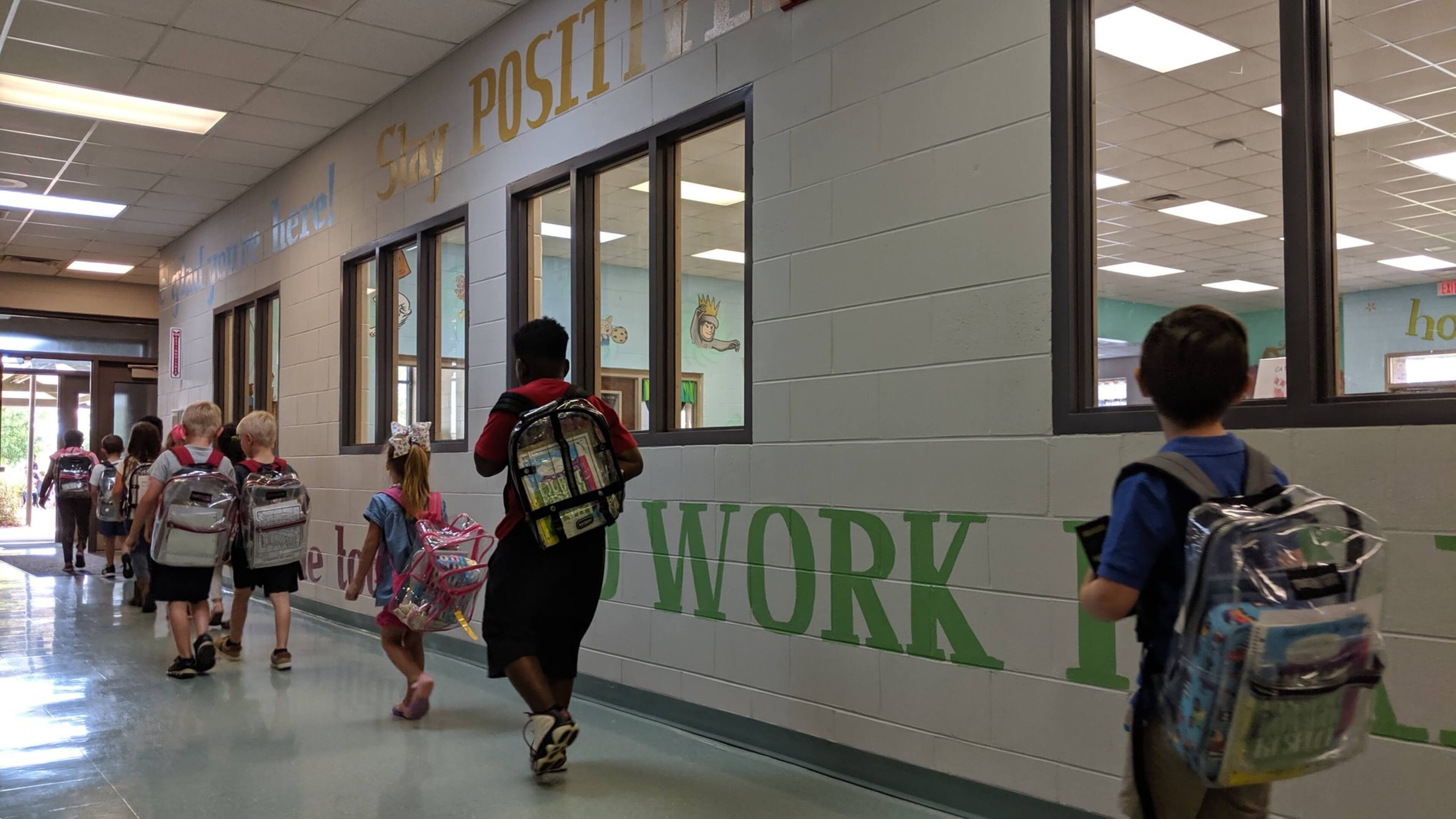Students file out the front door at Worth County Primary School on May 9, 2019. They are too young for state standardized tests, which start in third grade. But the K-2 school in Sylvester, Ga., used federal grant money to purchase special reading tests to gauge their progress, and on this day, they had their final tests of the year. (The walls are covered with words to emphasize the focus on literacy.) Like all Georgia school districts, Worth County is now getting more federal dollars — an additional $1.1 million — towards coronavirus-related costs.