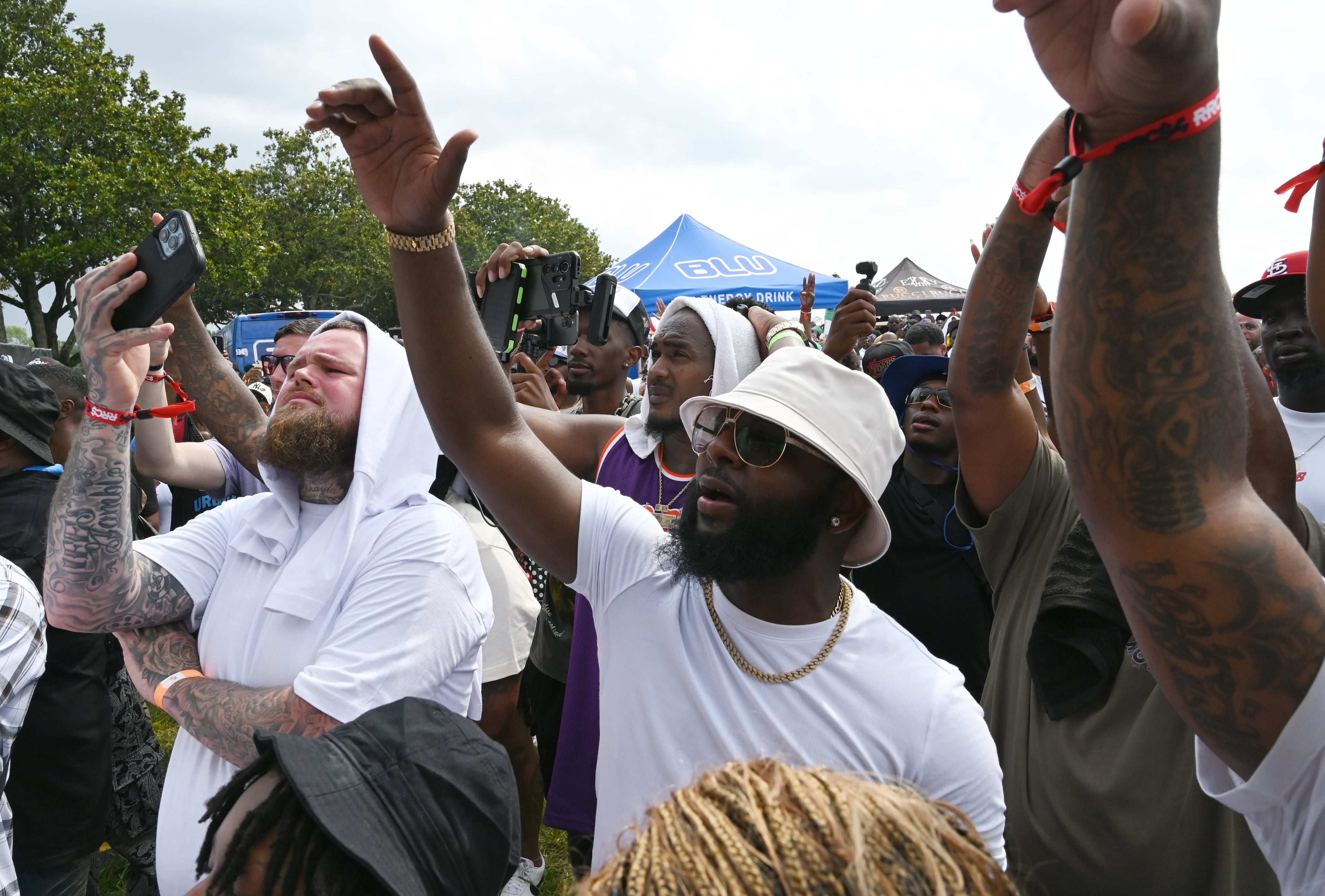 Attendees enjoy a live music performance by Rick Ross during the 4th Annual Rick Ross Car and Bike Show, Saturday, June 7, 2025, in Fayetteville. The 4th Annual Rick Ross Car and Bike Show will include a vendor market with more than 30 vendors, food trucks, fleets of classic/custom automobiles, luxury vehicles, boats, RVs and trailers on the front of the mansion. Stage performances include Plies, Ross' new signee Nino Breeze and Ross himself. (Hyosub Shin / AJC)
