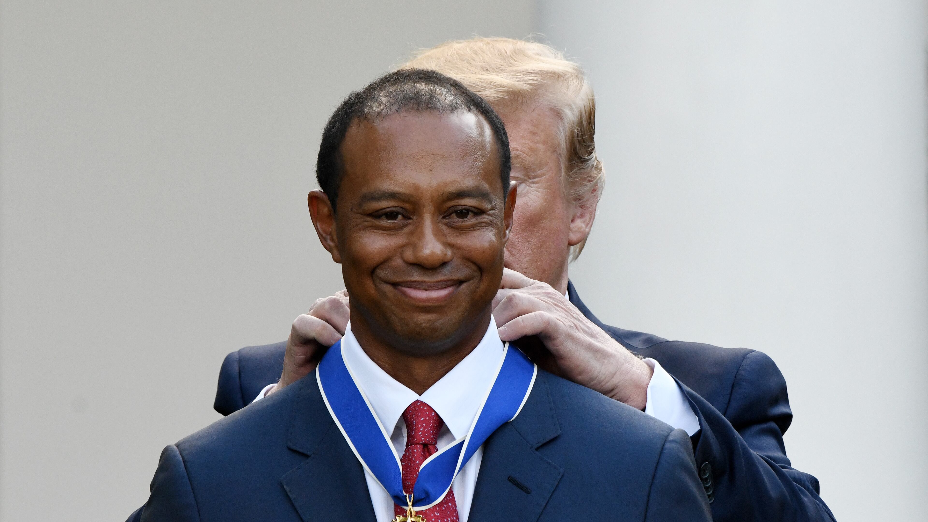 Tiger Woods happily receives the nation's highest civilian honor, the Presidential Medal of Freedom, during a ceremony in the Rose Garden at the White House. (Olivier Douliery/Abaca Press/TNS)