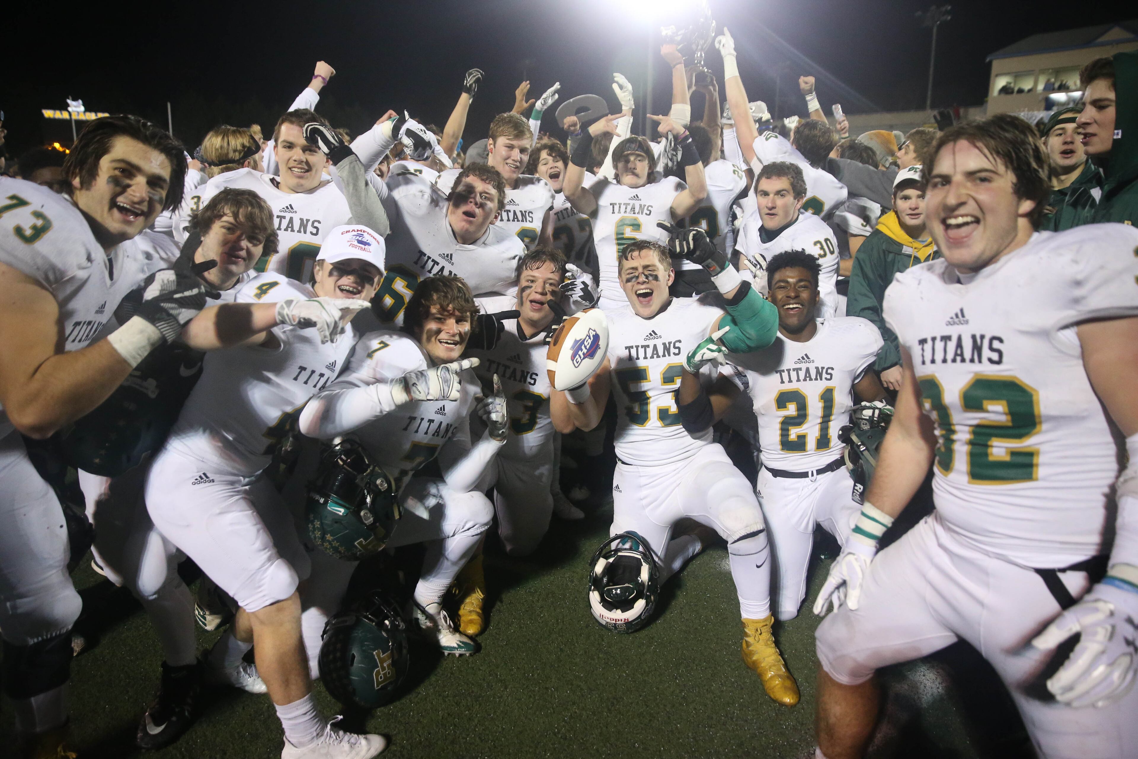 Blessed Trinity players celebrate after their win against Marist during the Class AAAA Championship game at Marist School Friday, December 15, 2017, in Atlanta. Blessed Trinity won 16-7. PHOTO / JASON GETZ