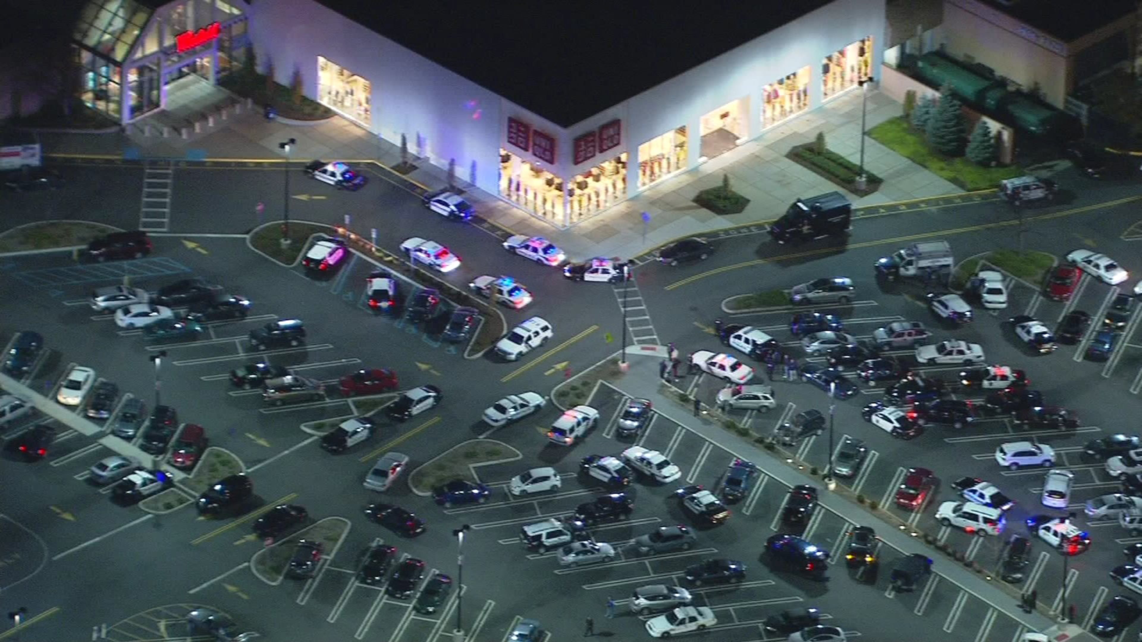 In this image provided by News 12 New Jersey, authorities converge on Garden State Plaza Mall, late Monday, Nov. 4, 2013, in Paramus, N.J., after there were reports of multiple shots being fired inside the mall. (AP Photo/News 12 New Jersey)