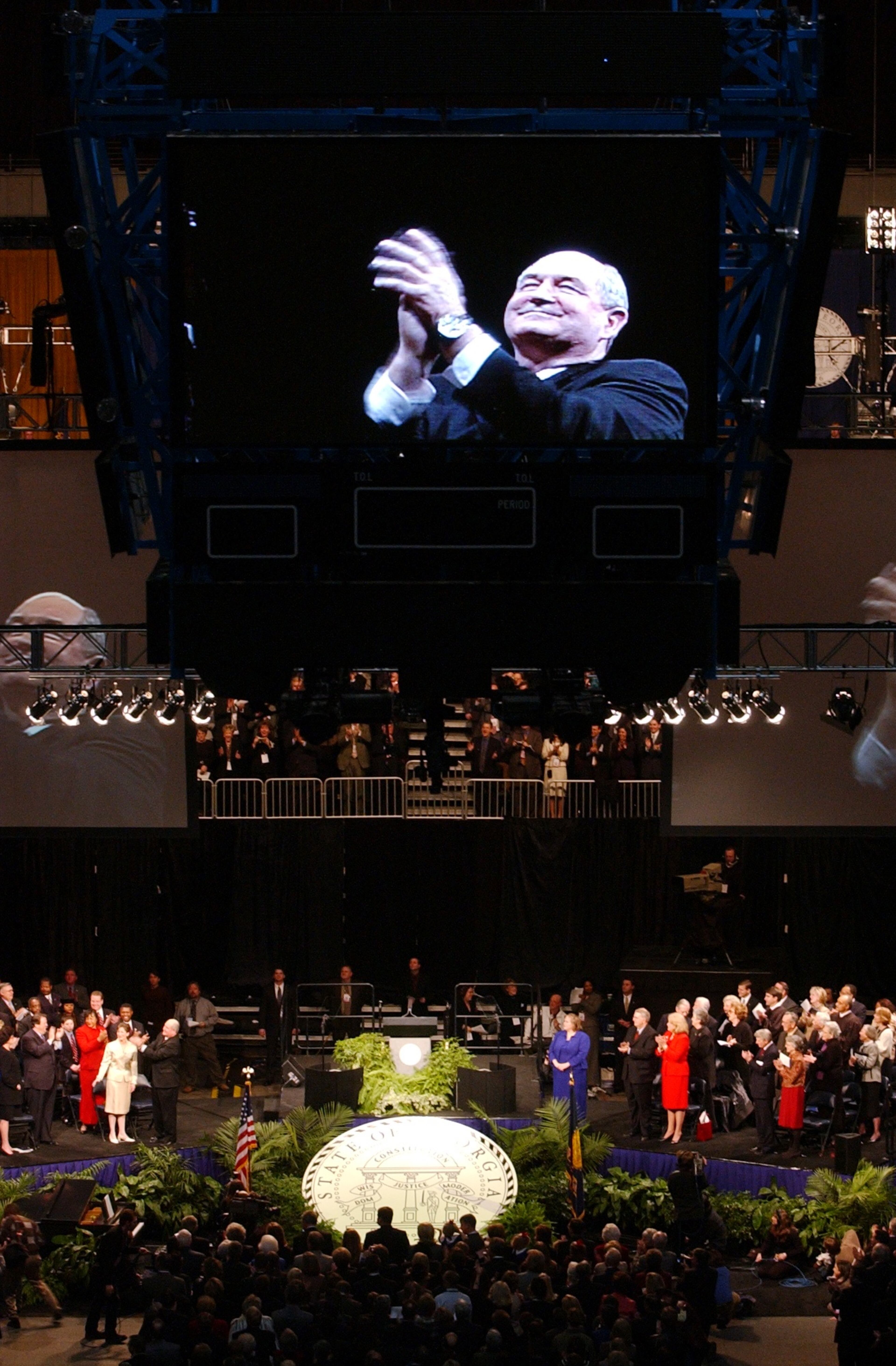 Sonny Perdue was inaugurated as Georgia's 81st Governor on Monday Jan, 13, 2003. In this file photo, Perdue applaudes the crowd at his inauguration ceremony at Phillips Arena. (Kimberly Smith/staff)