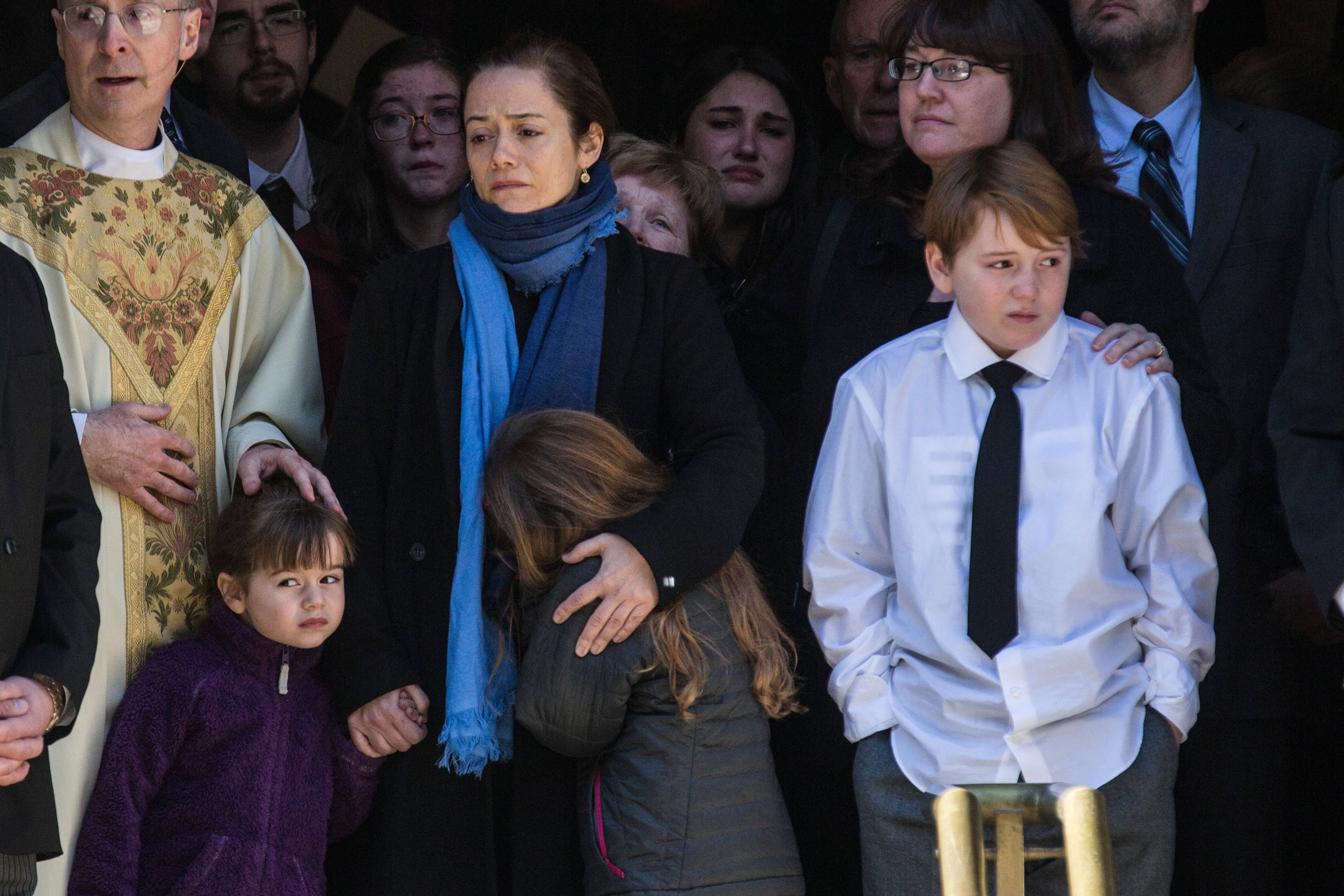 NEW YORK, NY - FEBRUARY 07: Mimi O'Donnell (C), partner of actor Philip Seymour Hoffman, along with their children (L-R), Willa Hoffman, Tallulah Hoffman and Cooper Hoffman, watch as the casket carrying Hoffman, who died of an alleged drug overdose on February 1, 2014, leaves Hoffman's funeral service at St. Ignatius Of Loyola on February 7, 2014 in New York City. Hoffman was allegedly found dead in his bathroom with a needle in his arm. (Photo by Andrew Burton/Getty Images)