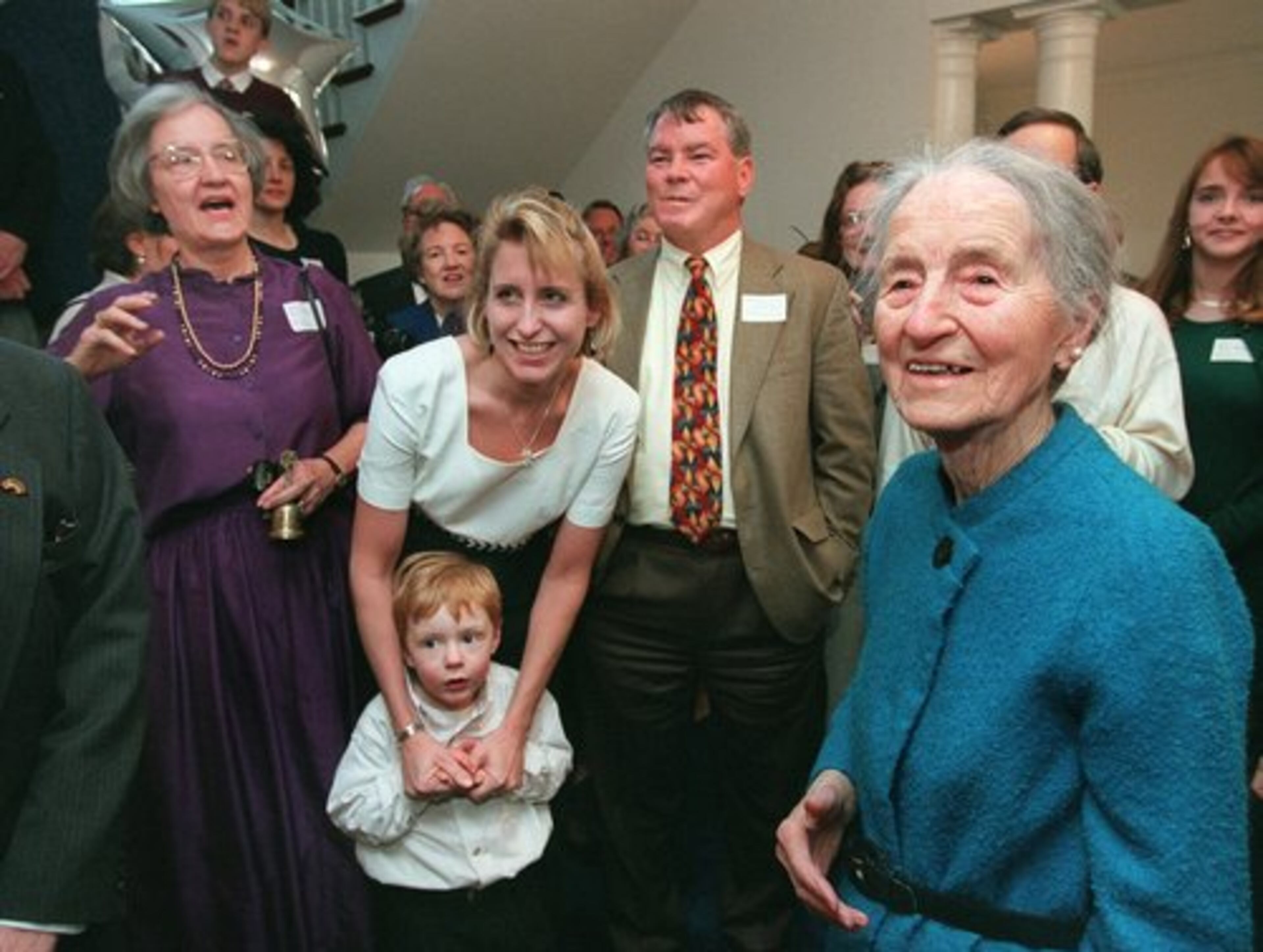 Denmark, right, chuckles as her daughter Mary Hutcherson (left, in purple) conducts a family 'roll call' during Denmark's 100th birthday celebration at her home in Alpharetta on Sunday, Feb. 1, 1998. Family members, friends and patients packed the country home for the party and took part in meeting, greeting, laughing and reuniting - and also a huge cake shaped like a 100, topped with 100 blue candles.